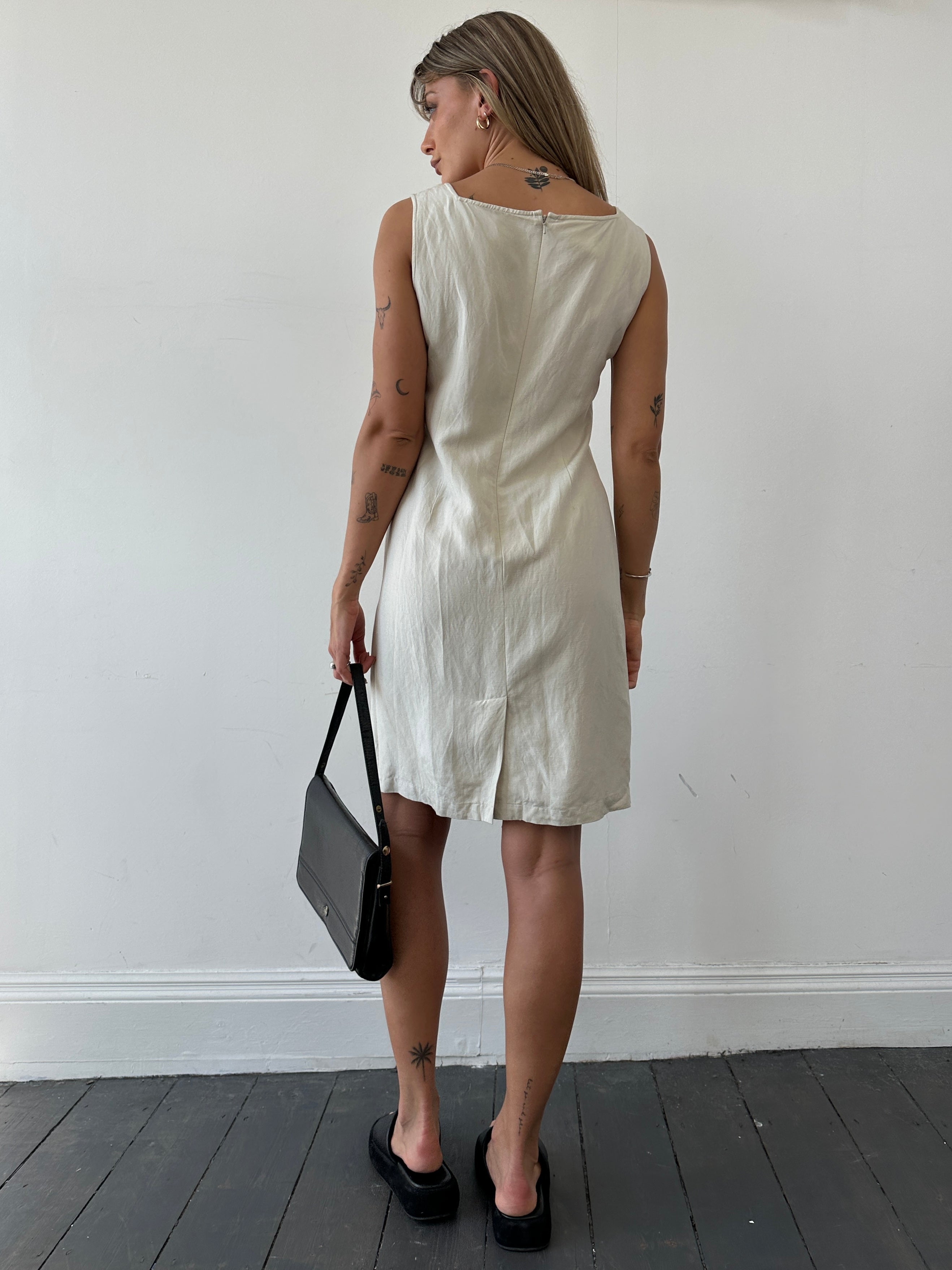 Laura Ashley silk linen square neck midi dress in size M displayed on a hanger, showcasing its elegant design and lightweight fabric.