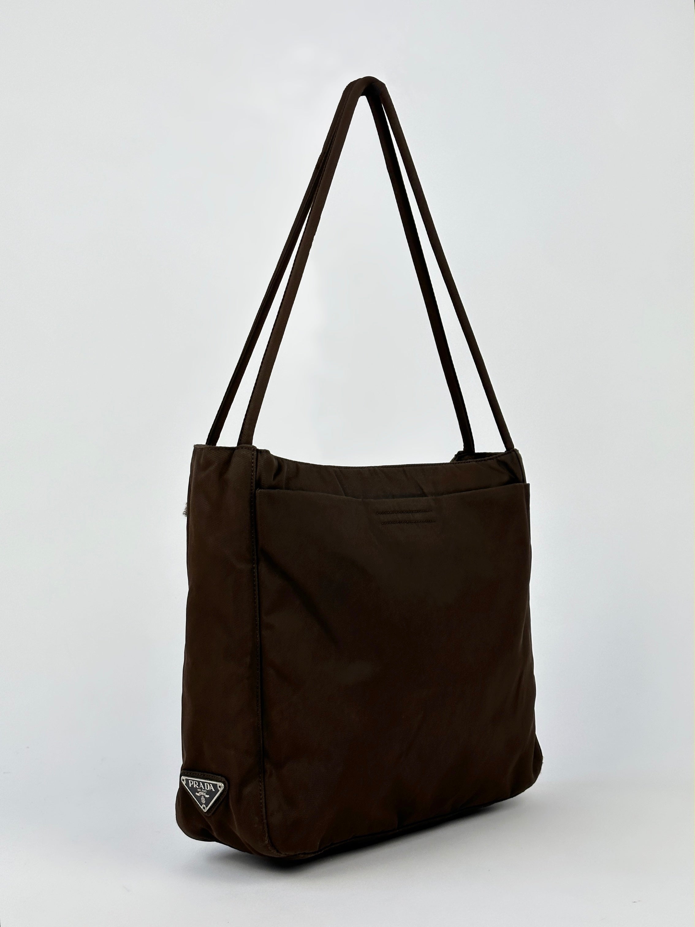 Prada Tessuto nylon tote bag with top handles and spacious interior, featuring a sleek, modern design perfect for everyday use.