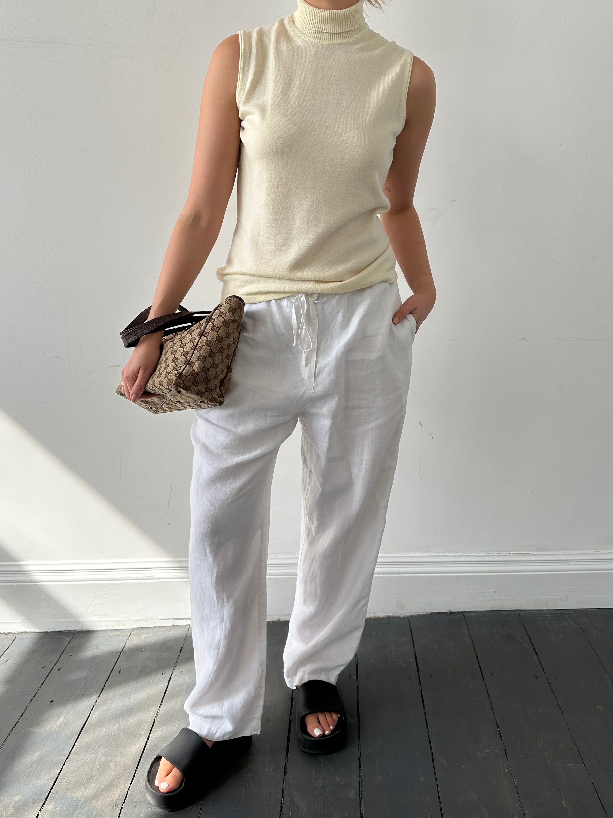 Armani Collezioni sleeveless turtleneck jumper in virgin wool, featuring a fitted design and classic turtle neck style.