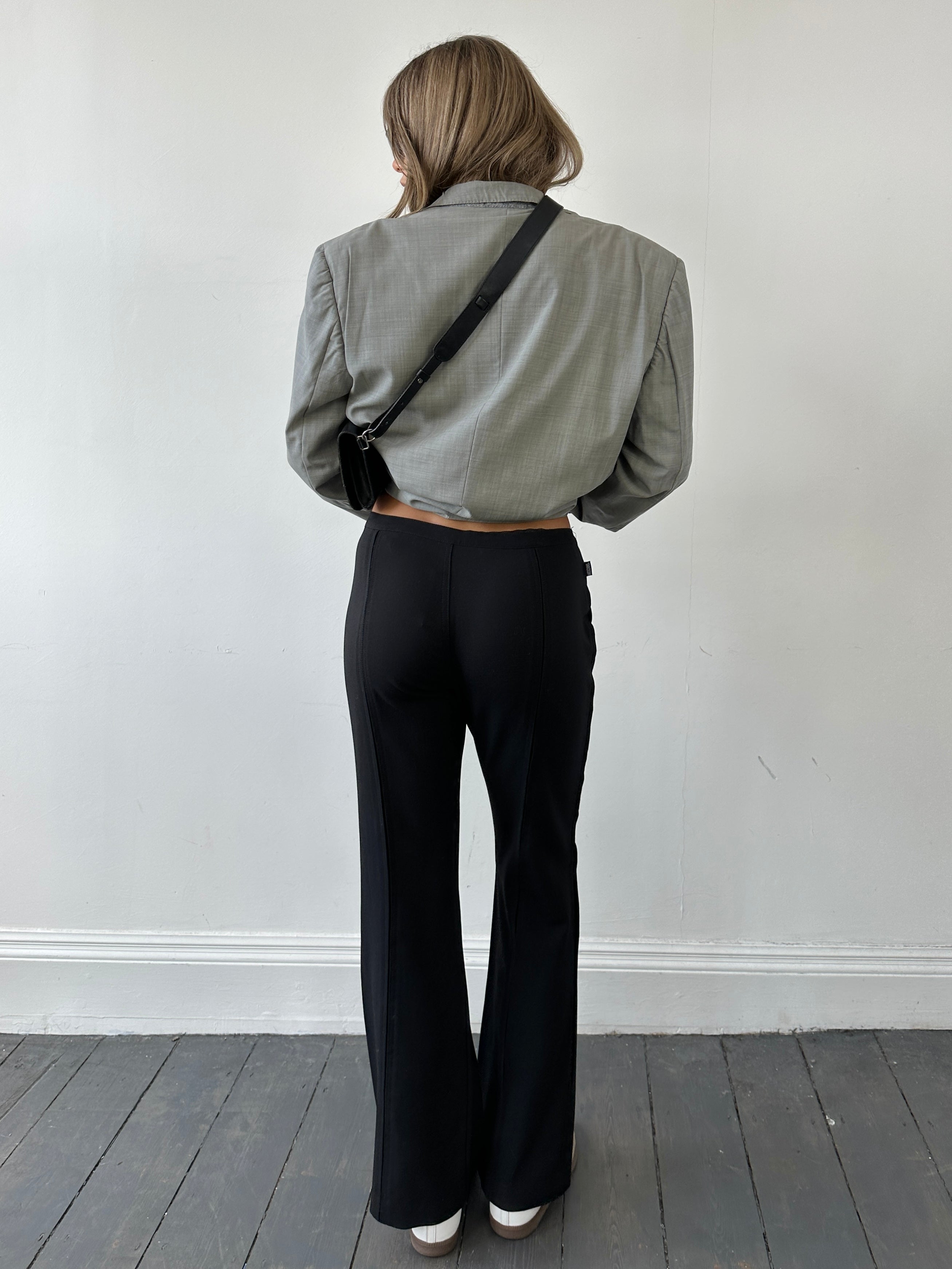 Moschino low waist flared wool trousers in virgin wool with a relaxed fit, shown on a model in size W34/UK 12.