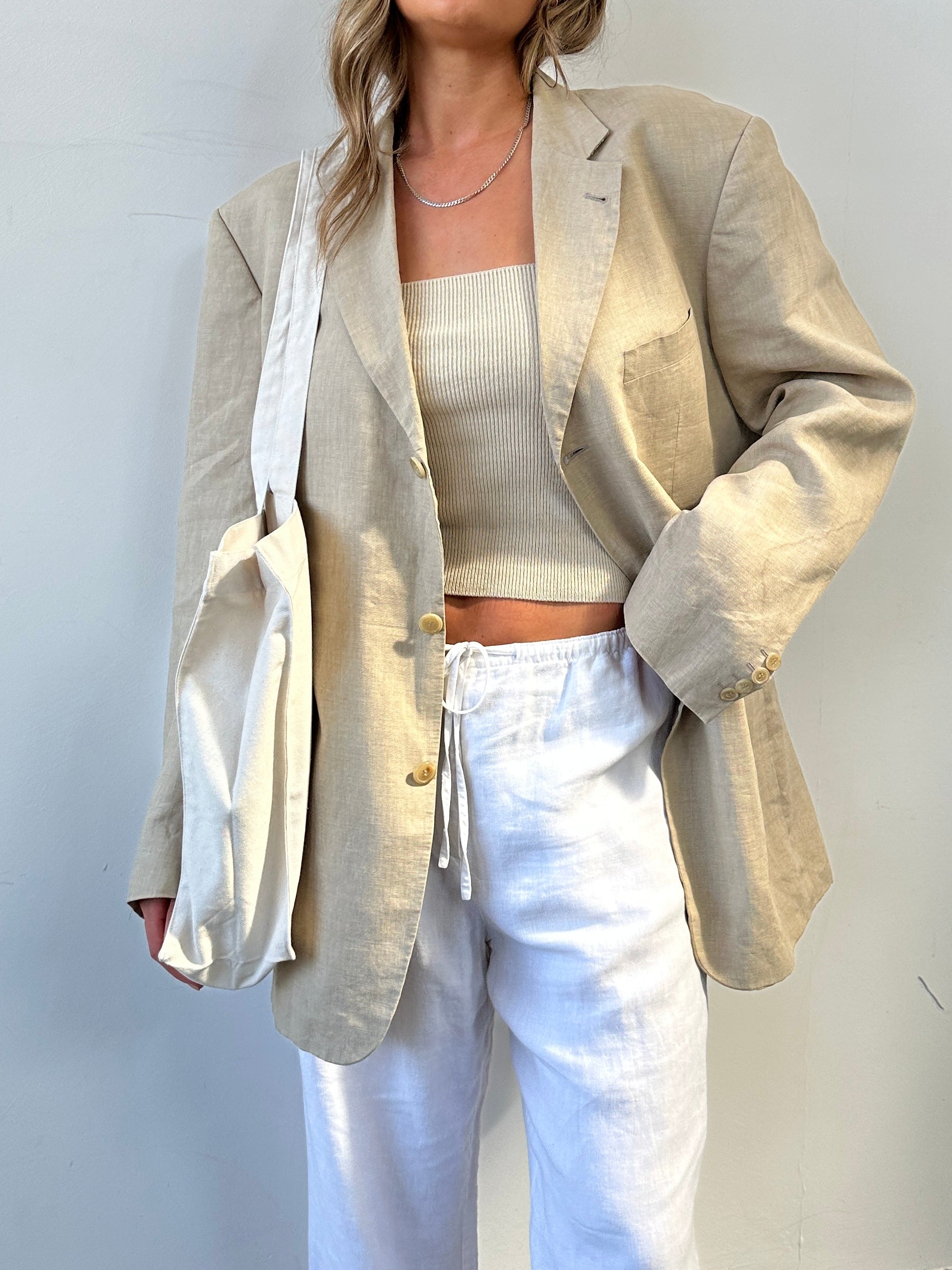 Hugo Boss boxy pure linen single-breasted blazer in XL, showing tailored fit and classic lapel on light-colored fabric.