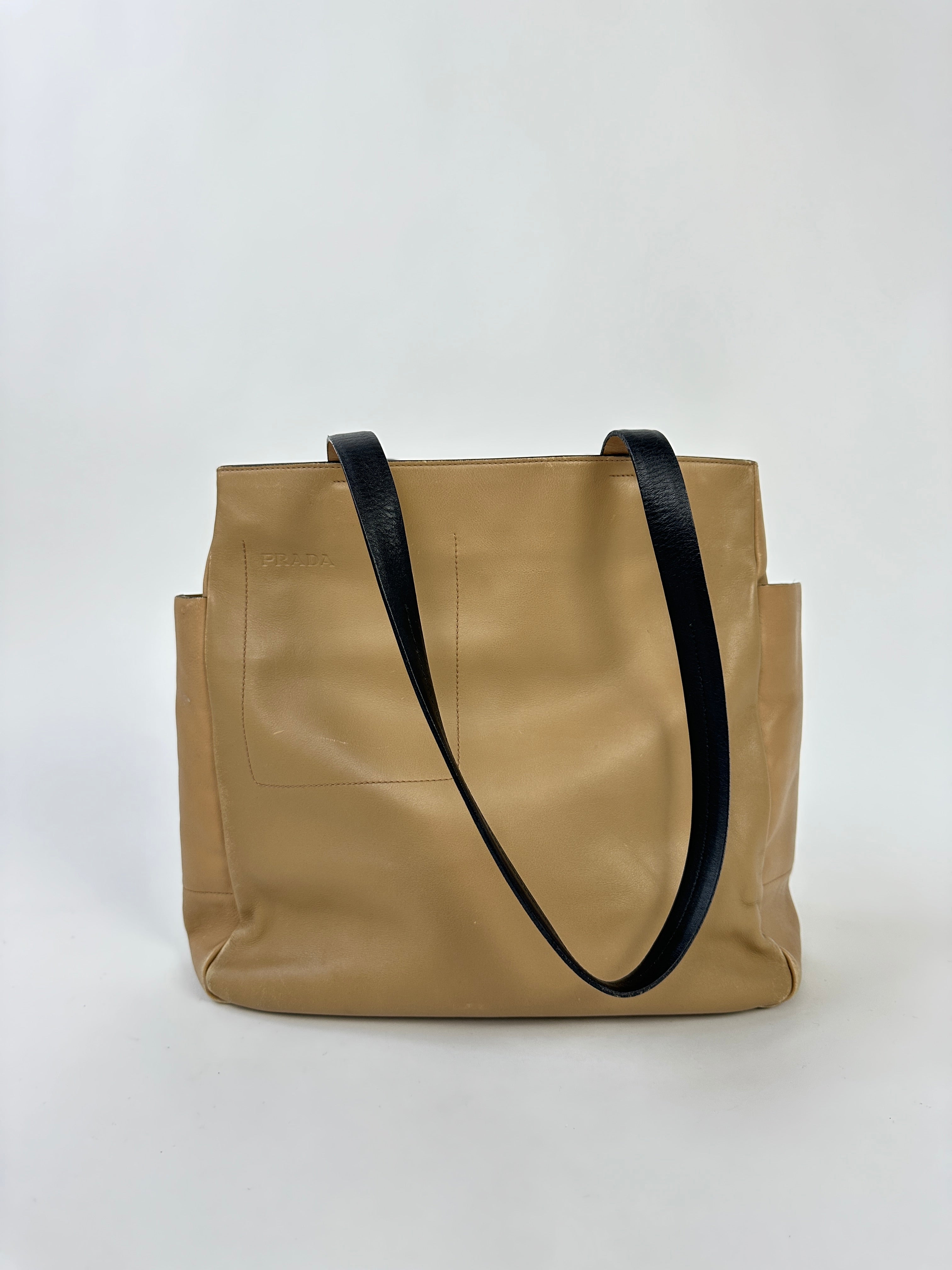 Prada contrast leather tote bag with sleek design, featuring sturdy handles and spacious interior for everyday use.