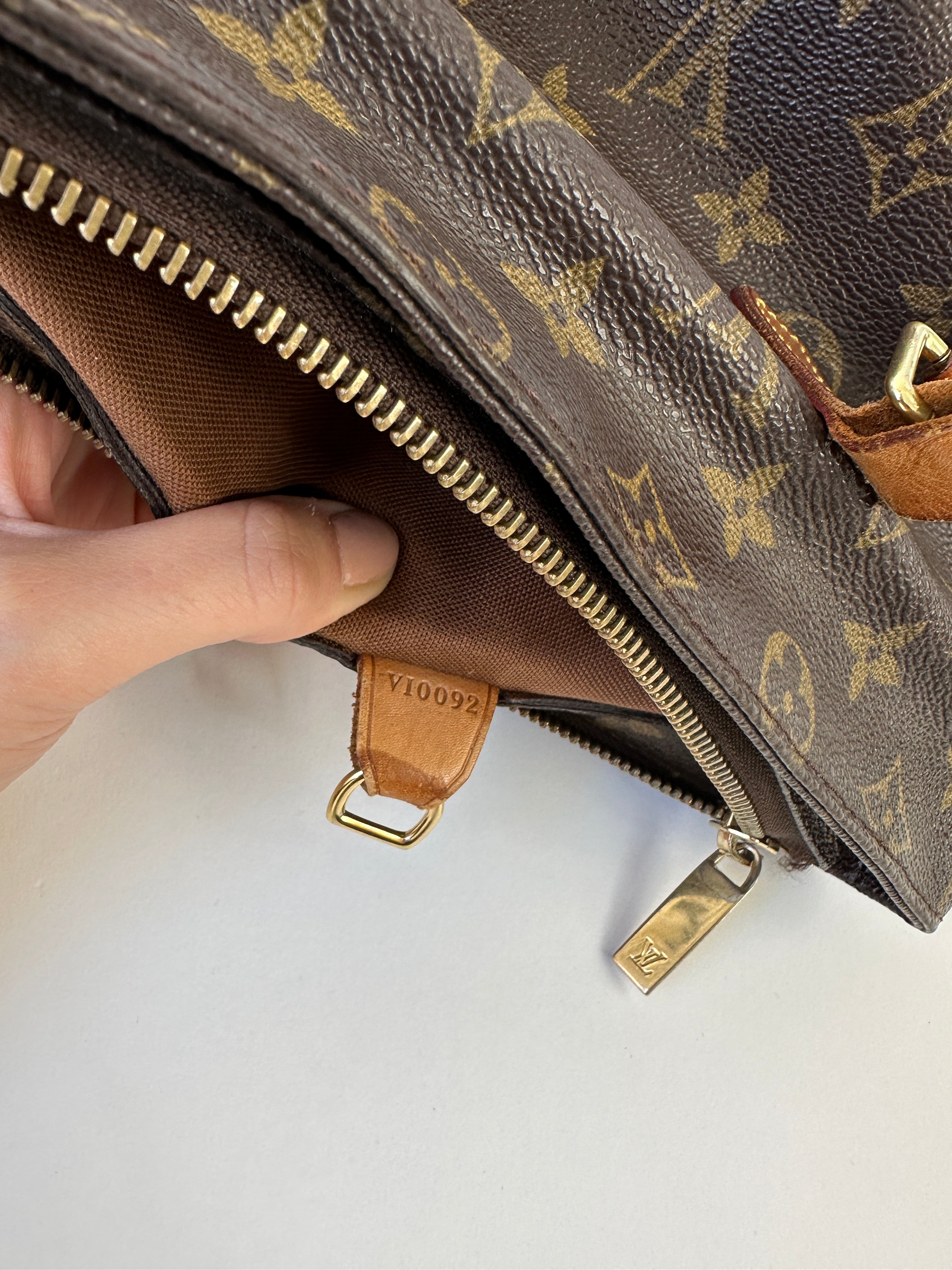 Louis Vuitton Cabas Mezzo Monogram shoulder bag with tan leather handles and signature LV monogram canvas.