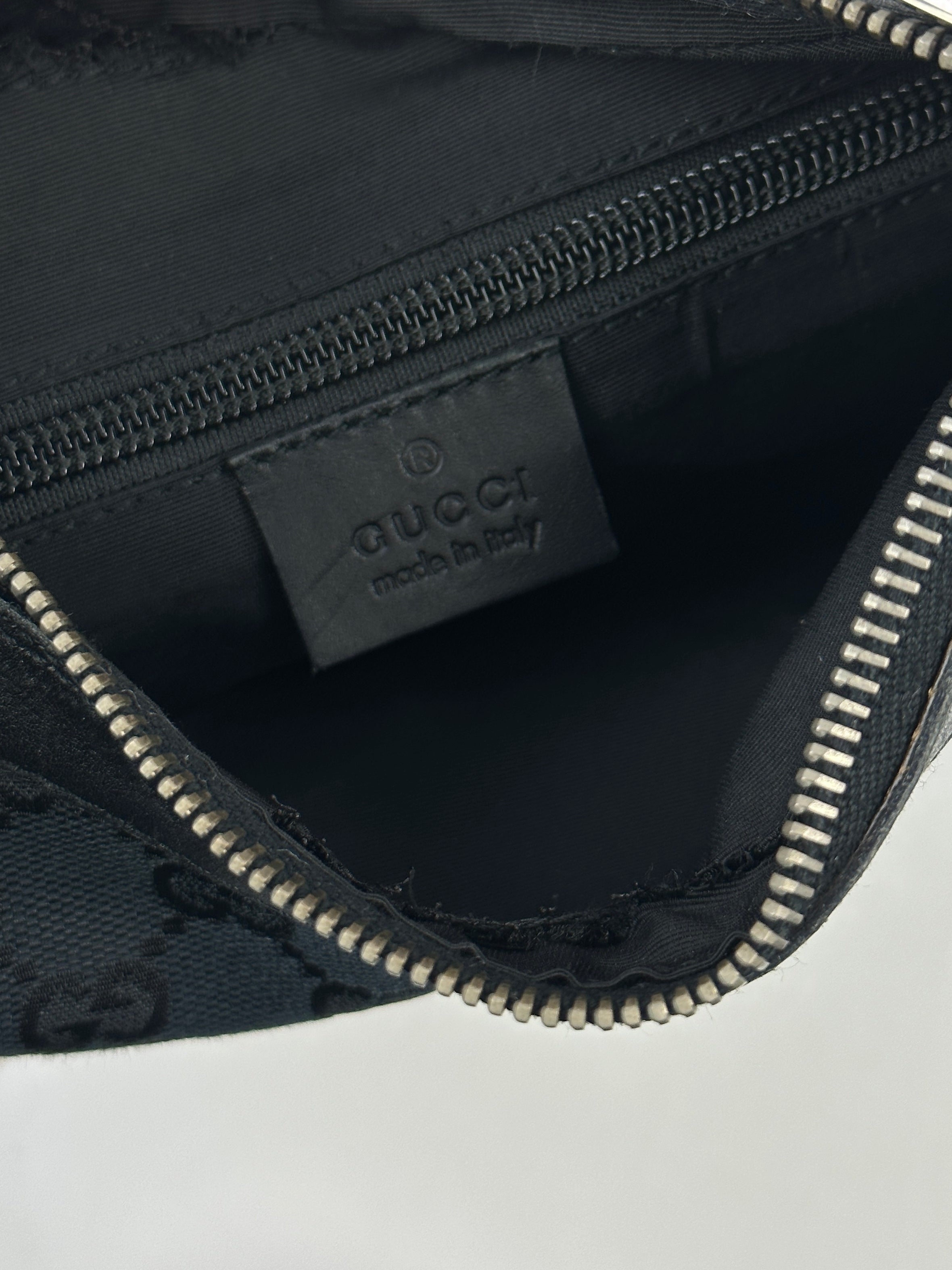 Gucci GG monogram canvas leather shoulder bag with gold-tone hardware and adjustable strap, stylish and spacious accessory.