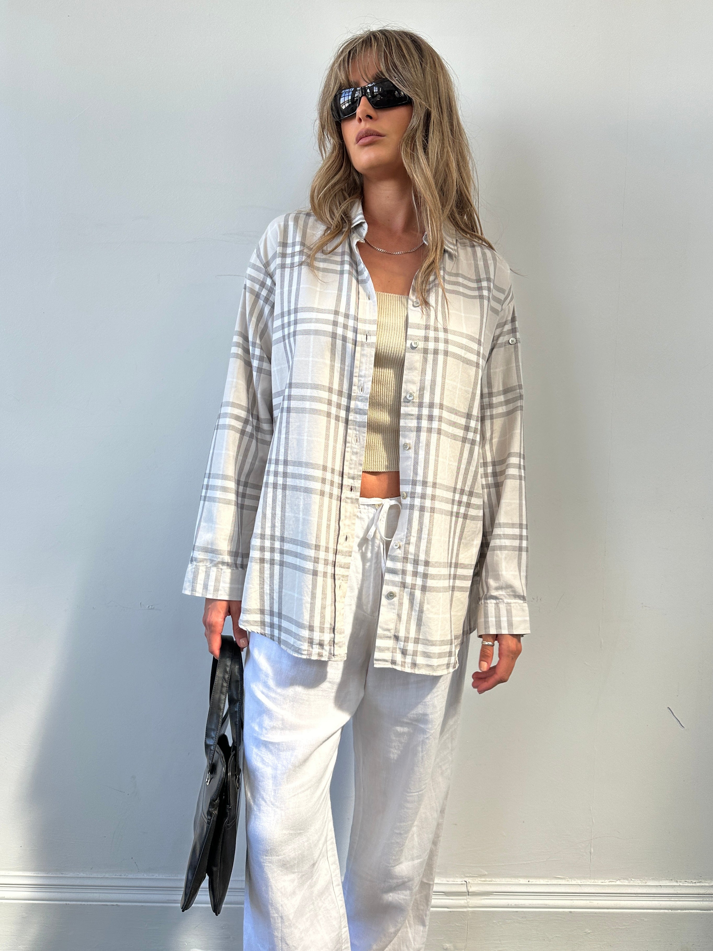 Burberry London Check cotton shirt in size L displayed on a hanger, featuring classic plaid pattern and button-down collar.