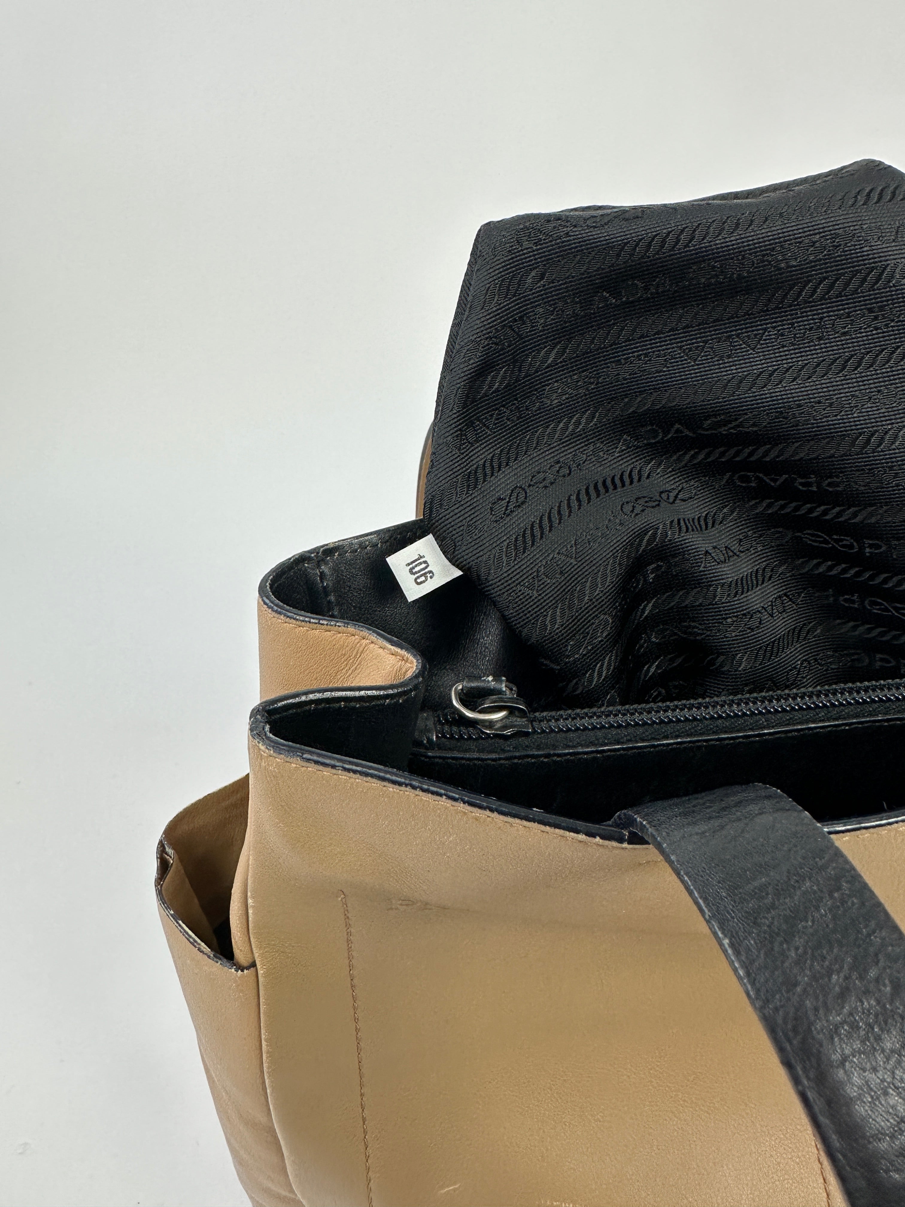 Prada contrast leather tote bag with sleek design, featuring smooth leather and spacious interior for everyday use.