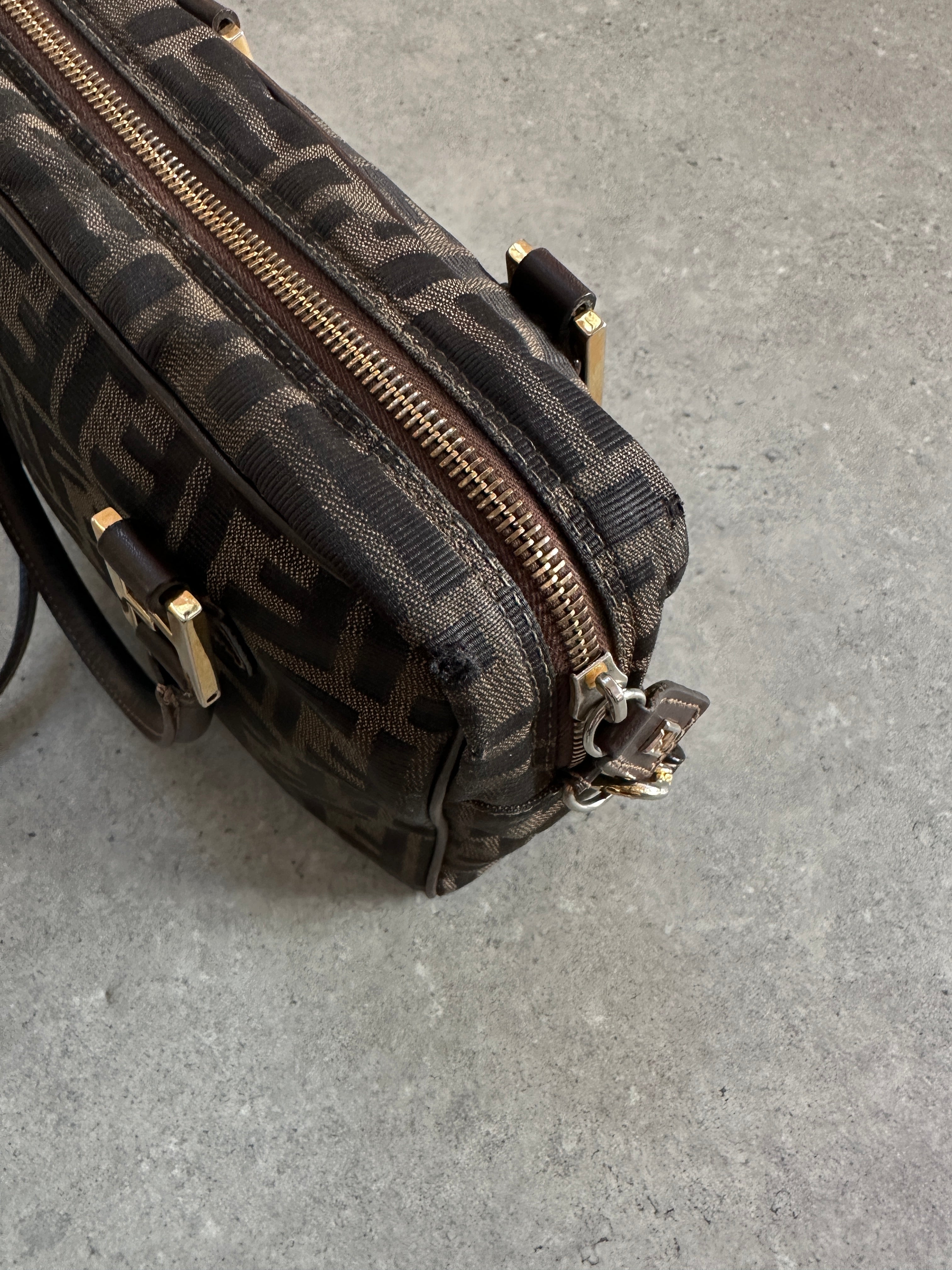 Fendi Zucca Monogram Crossbody Bag with adjustable strap and signature Fendi pattern, stylish and compact accessory.