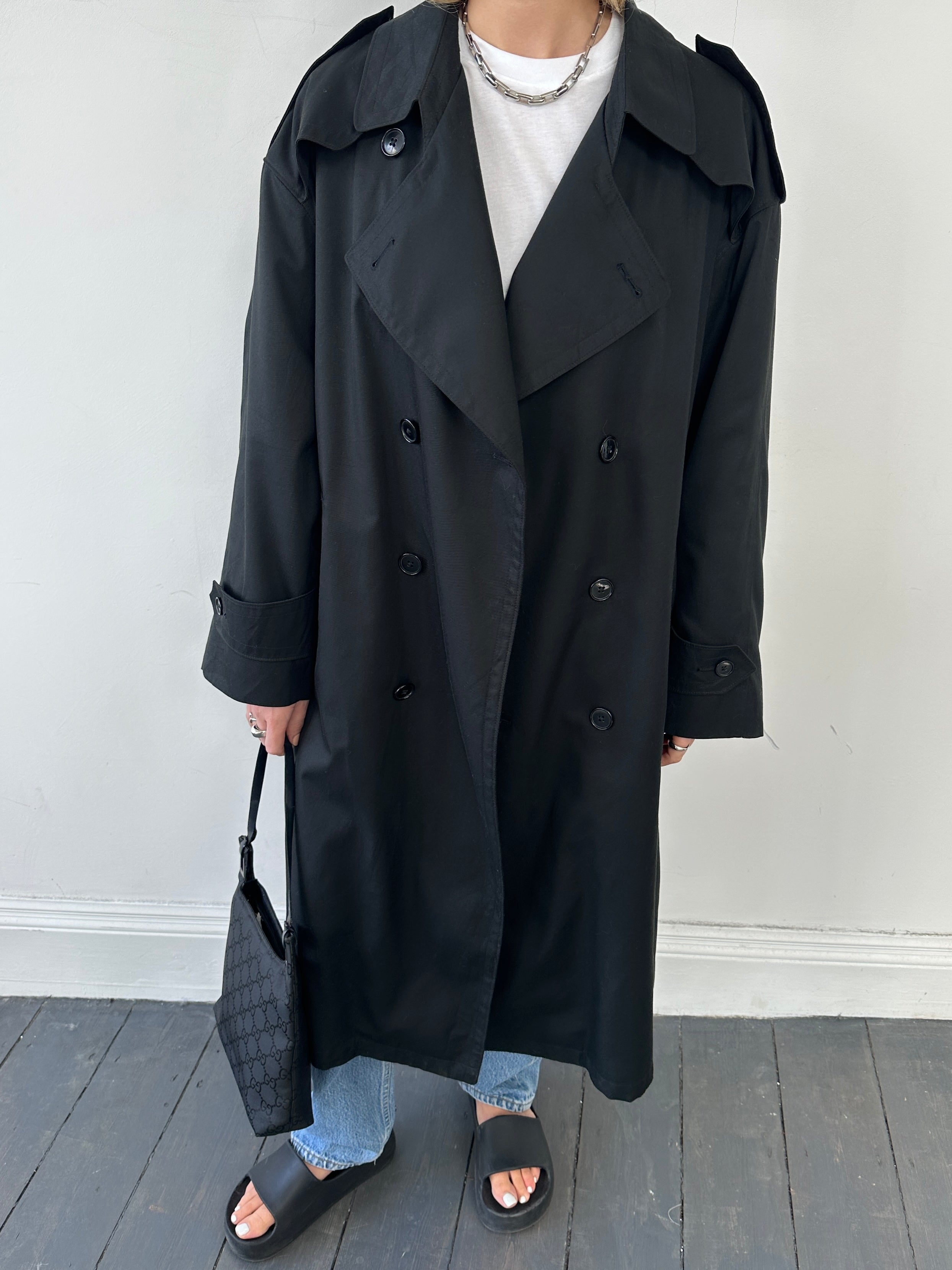 Christian Dior Monsieur double-breasted trench coat in beige, tailored with lapels, buttons, and belt, on a hanger.