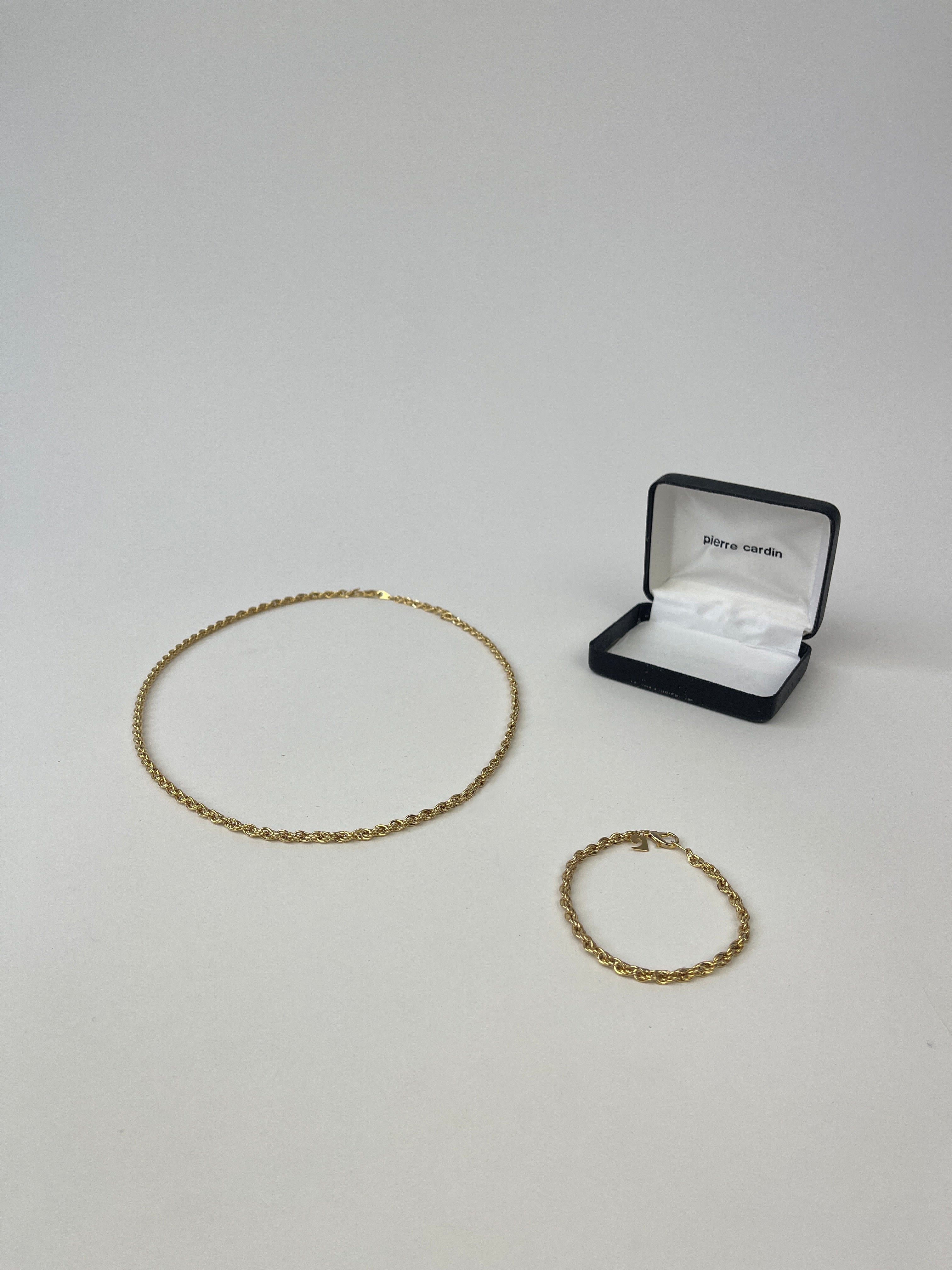 Pierre Cardin gold plated necklace and bracelet chain set, featuring stylish matching jewelry with a sleek design.