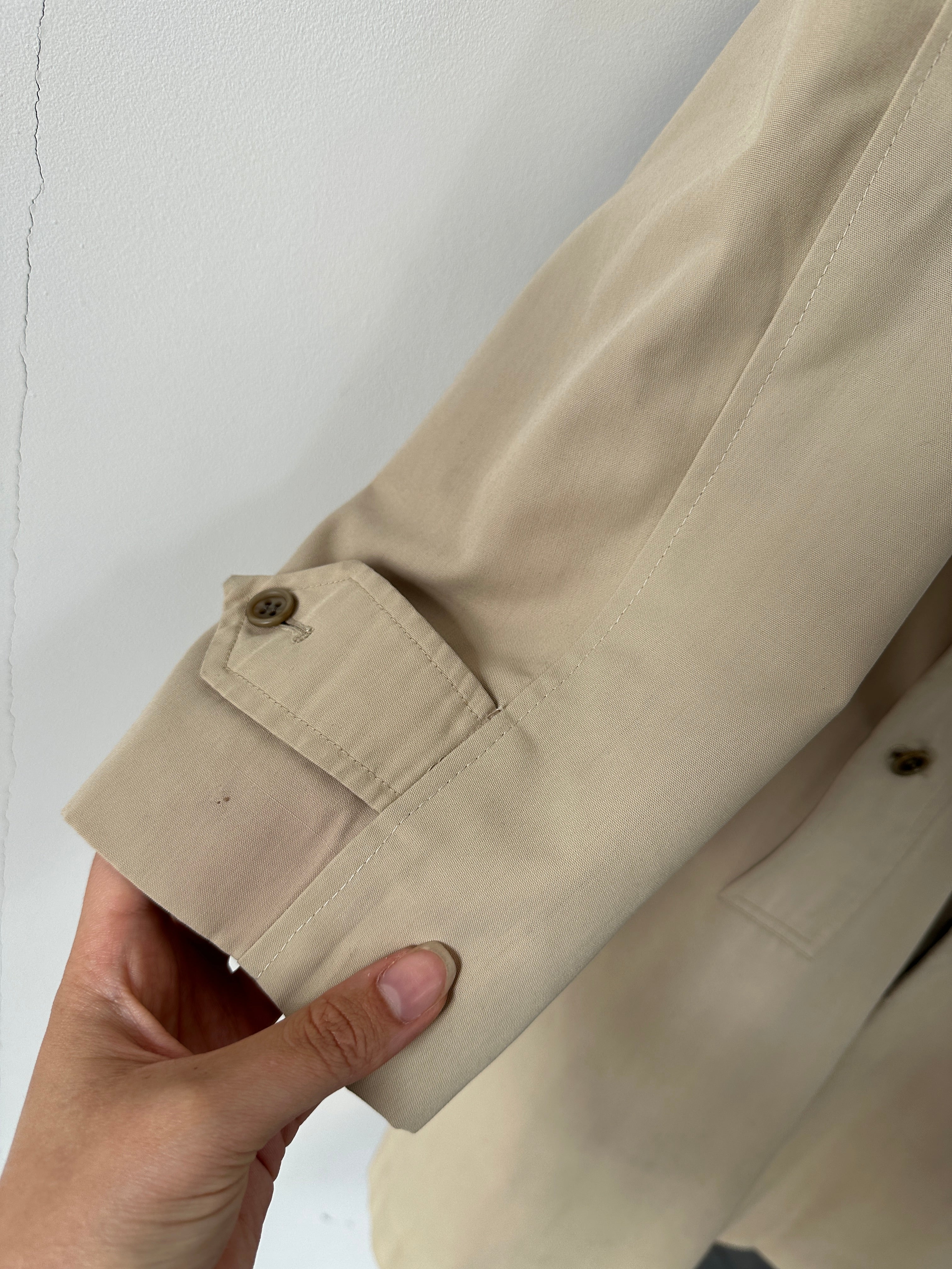Burberry Nova Check trench coat in size large, featuring classic plaid pattern and beige fabric, displayed on a hanger.