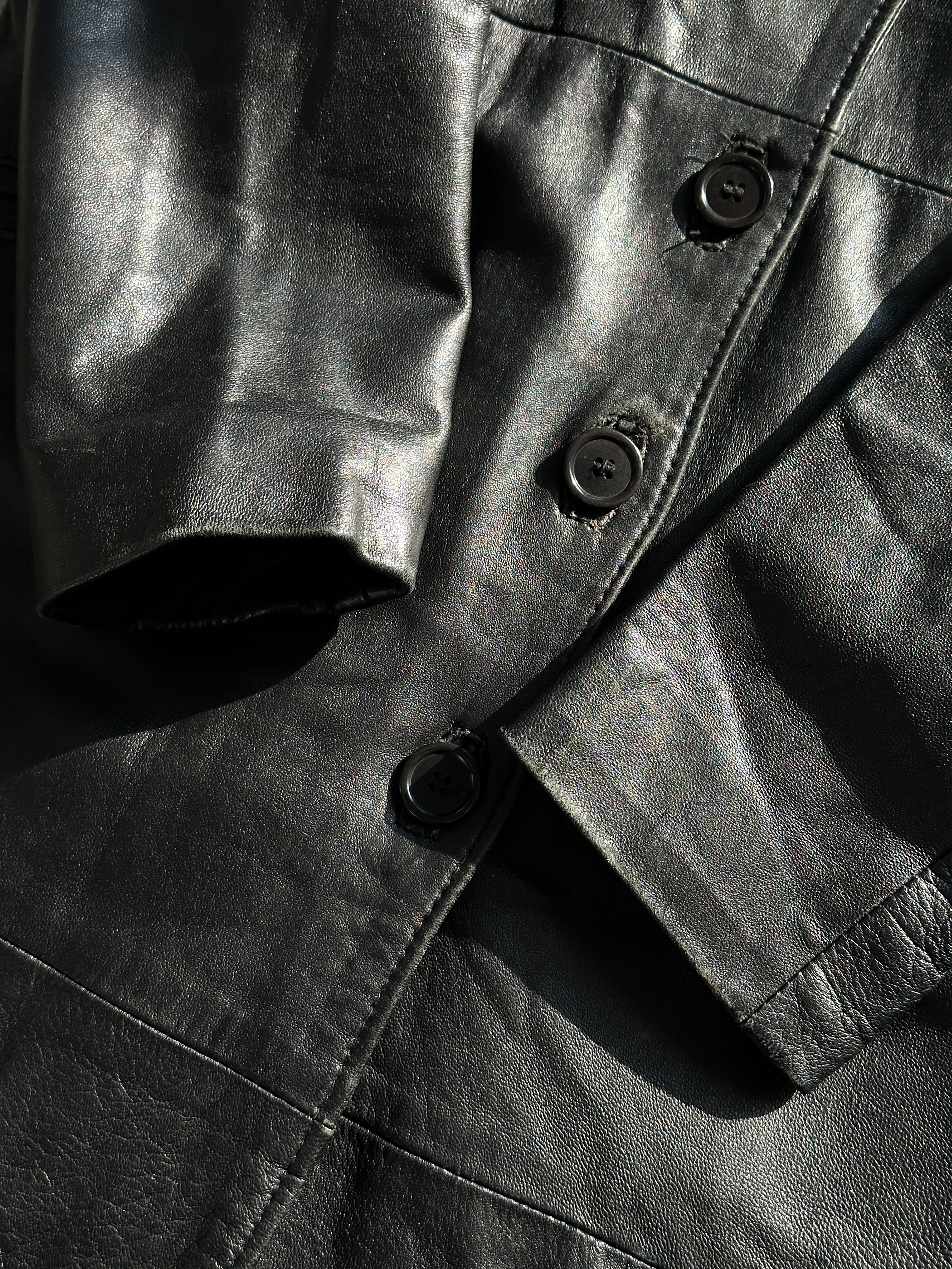 Vintage Italian vintage leather jacket in XS displayed on a hanger, showcasing classic style and rich leather texture.