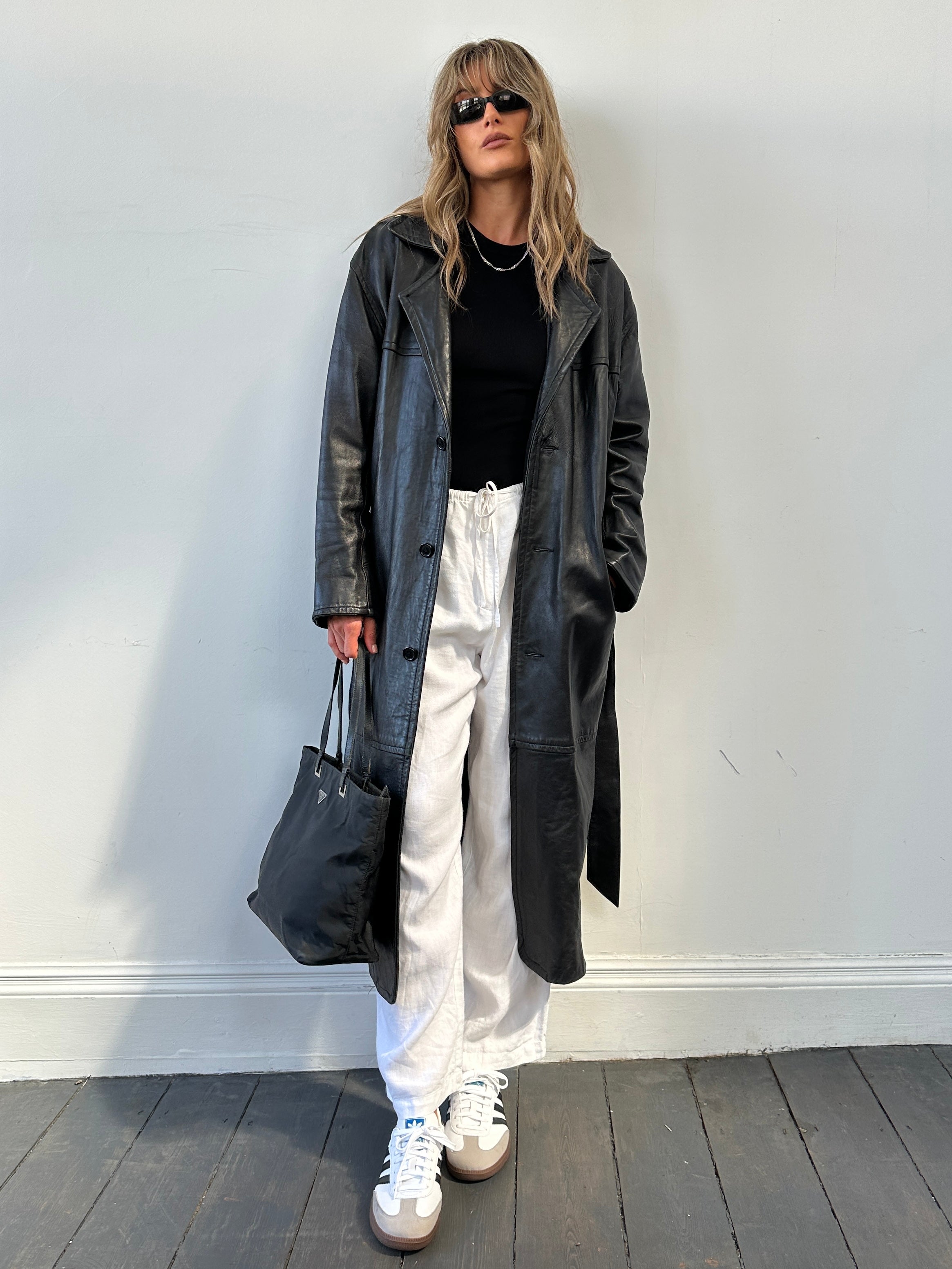 Vintage belted floor-length leather coat jacket, size M, showcasing classic design and rich leather texture.