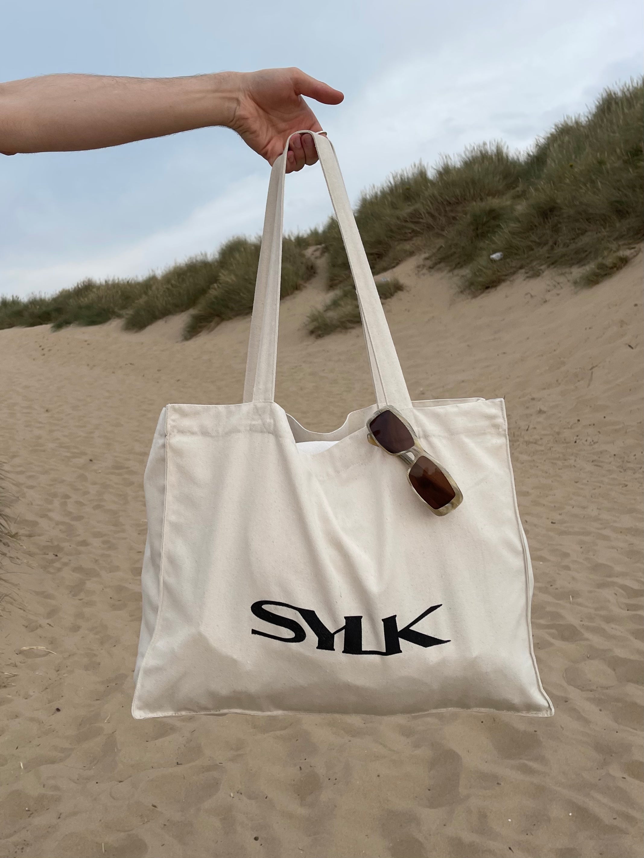 SYLK recycled cotton tote bag with natural handles and eco-friendly design, showcasing a spacious and stylish reusable bag.