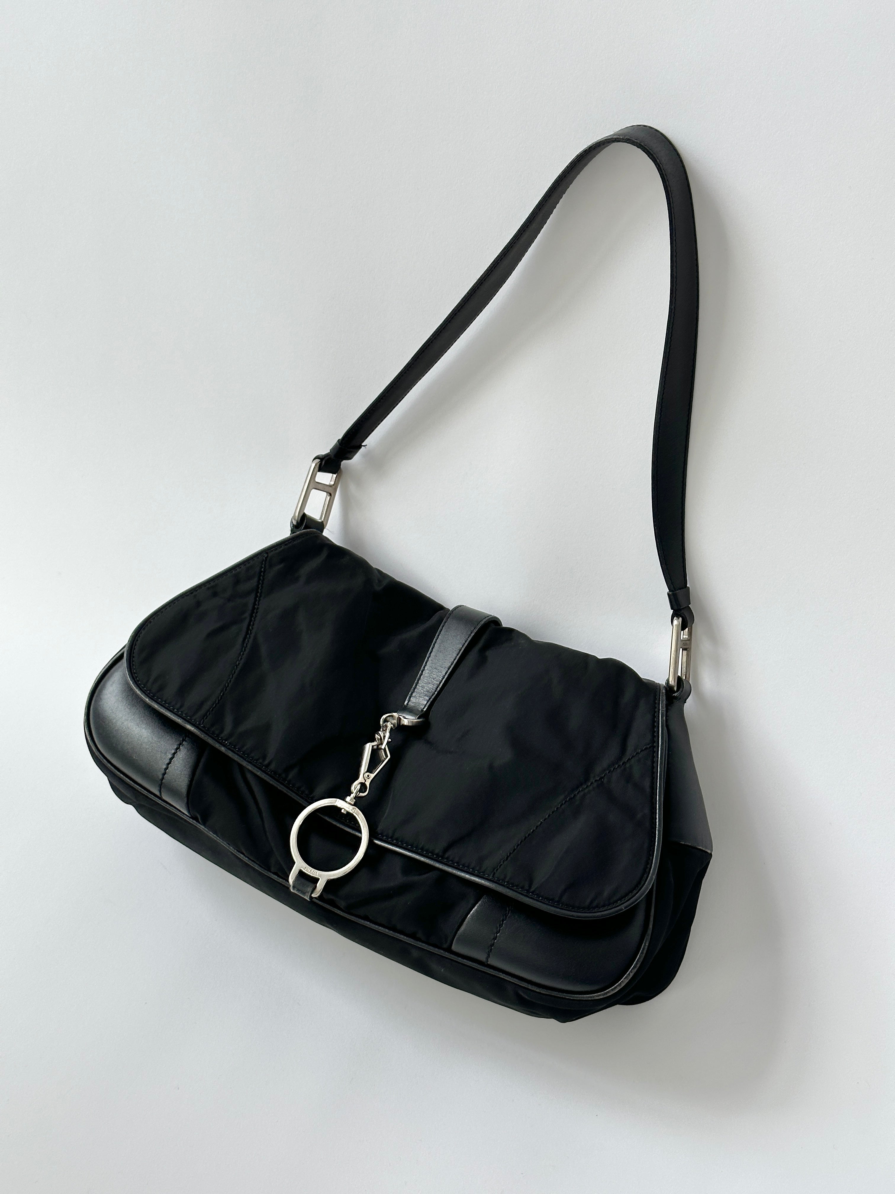 Prada 2000s Tessuto nylon double-sided shoulder bag with adjustable strap and Prada logo, featuring sleek, durable design.