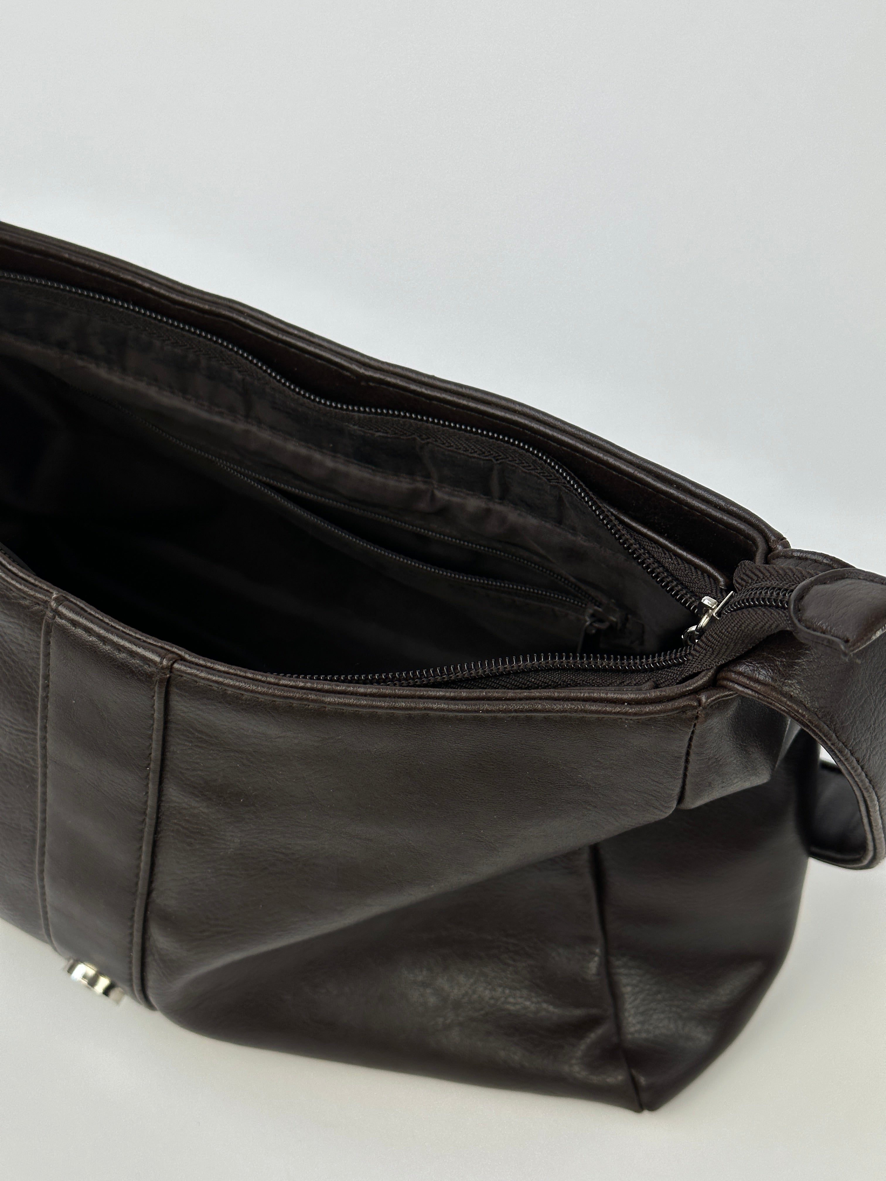 Vintage 2000s faux leather shoulder bag with adjustable strap and classic design, featuring a vintage-inspired look and textured surface.