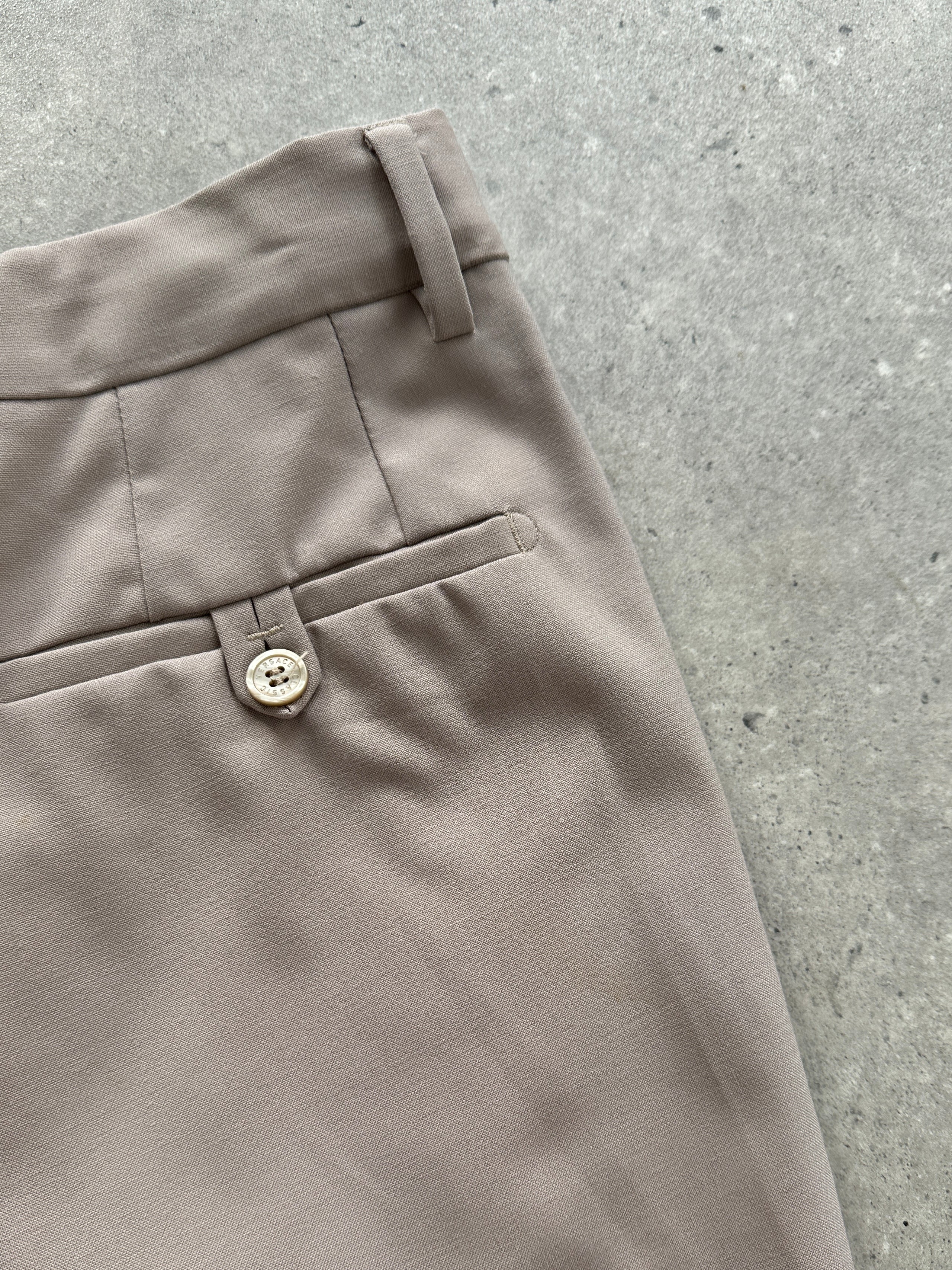 Versace single-breasted wool jumpsuit in size 42R/W30, tailored fit with lapel collar and sleek design, shown on a hanger.