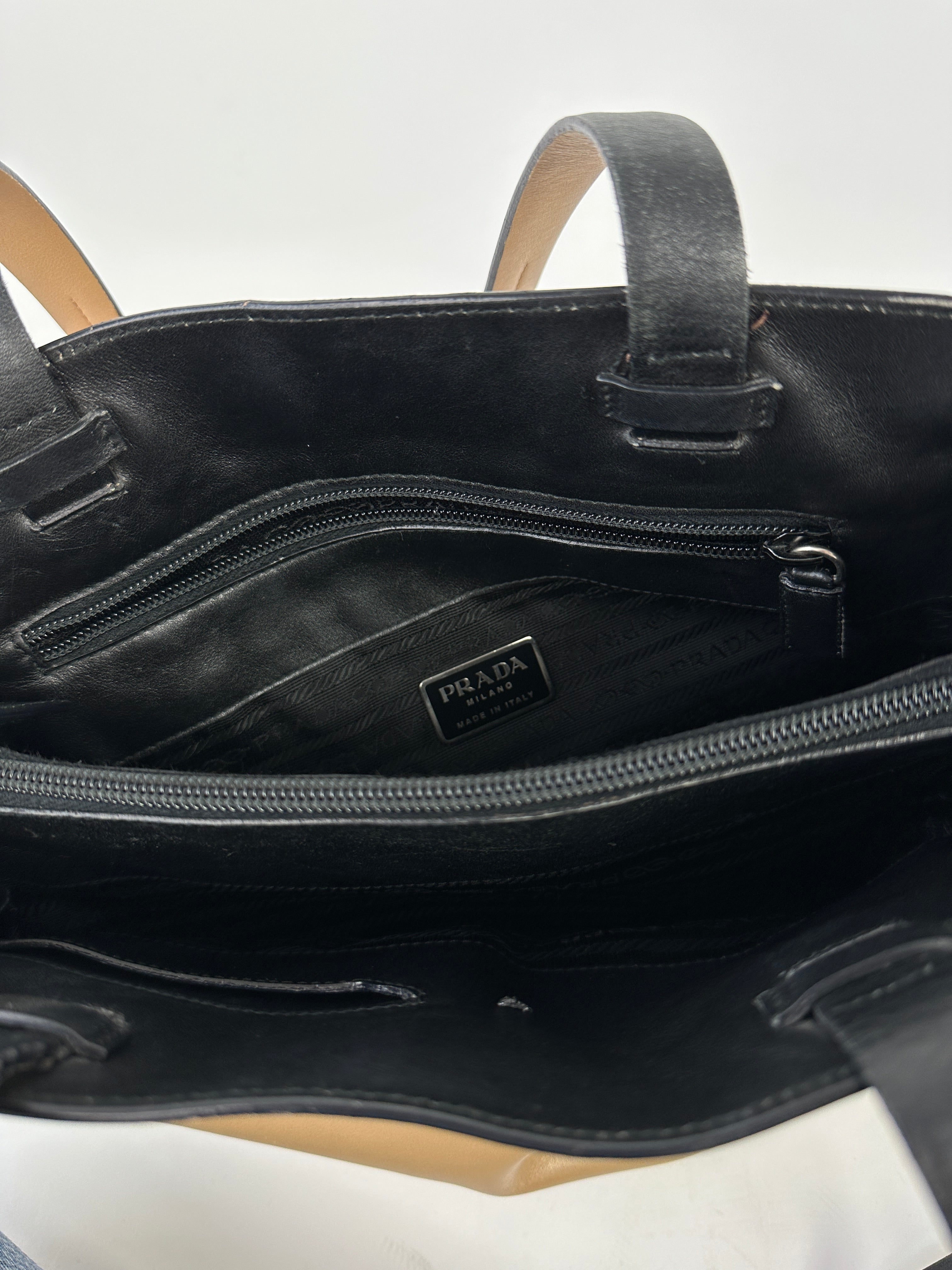 Prada contrast leather tote bag with sleek design, featuring sturdy handles and spacious interior for everyday use.