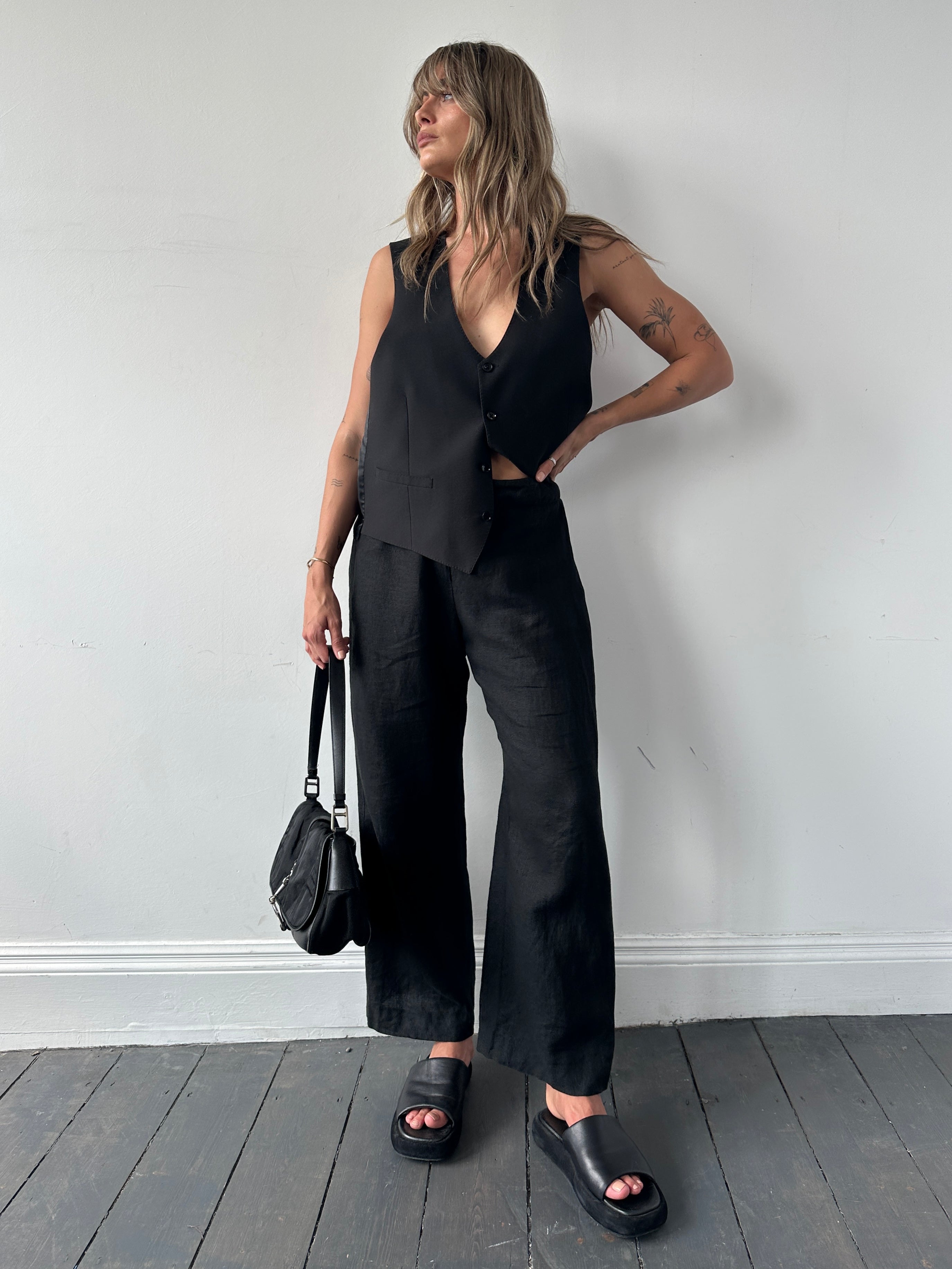 Jaeger linen wide leg elasticated trousers in natural color, showing relaxed fit and wide waistband on model.