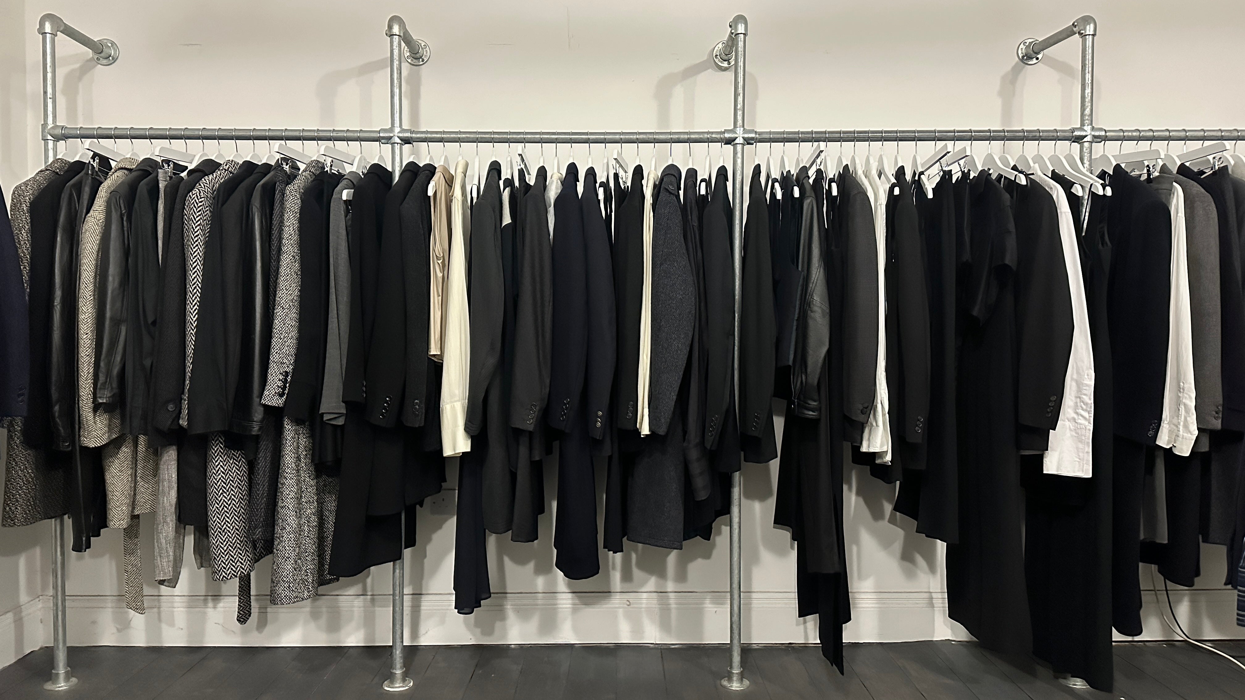 Vintage clothing displayed on designer rails at SYLK studio appointments in Manchester, showcasing curated fashion pieces.