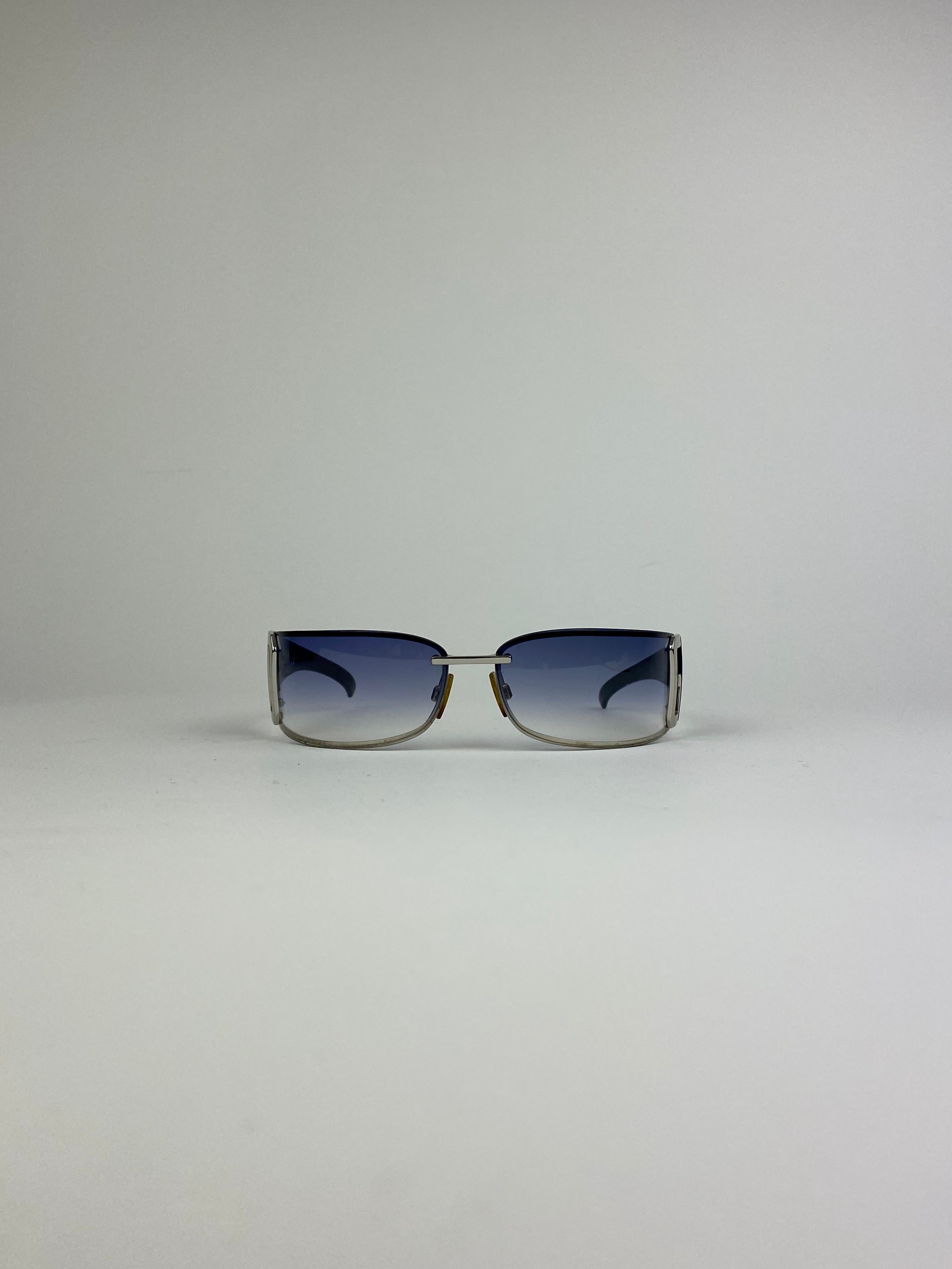 Dolce & Gabbana shield sunglasses with blue tinted lenses and sleek black frame, stylish and protective eyewear.