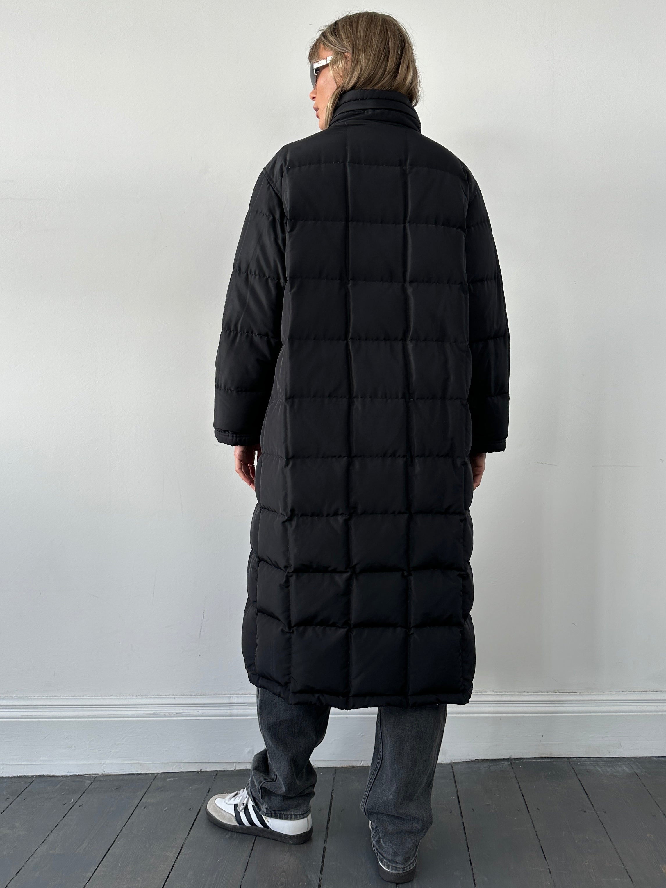 Fay floor-length down puffer coat in black, showcasing its quilted design, hood, and sleek style for cold weather wear.