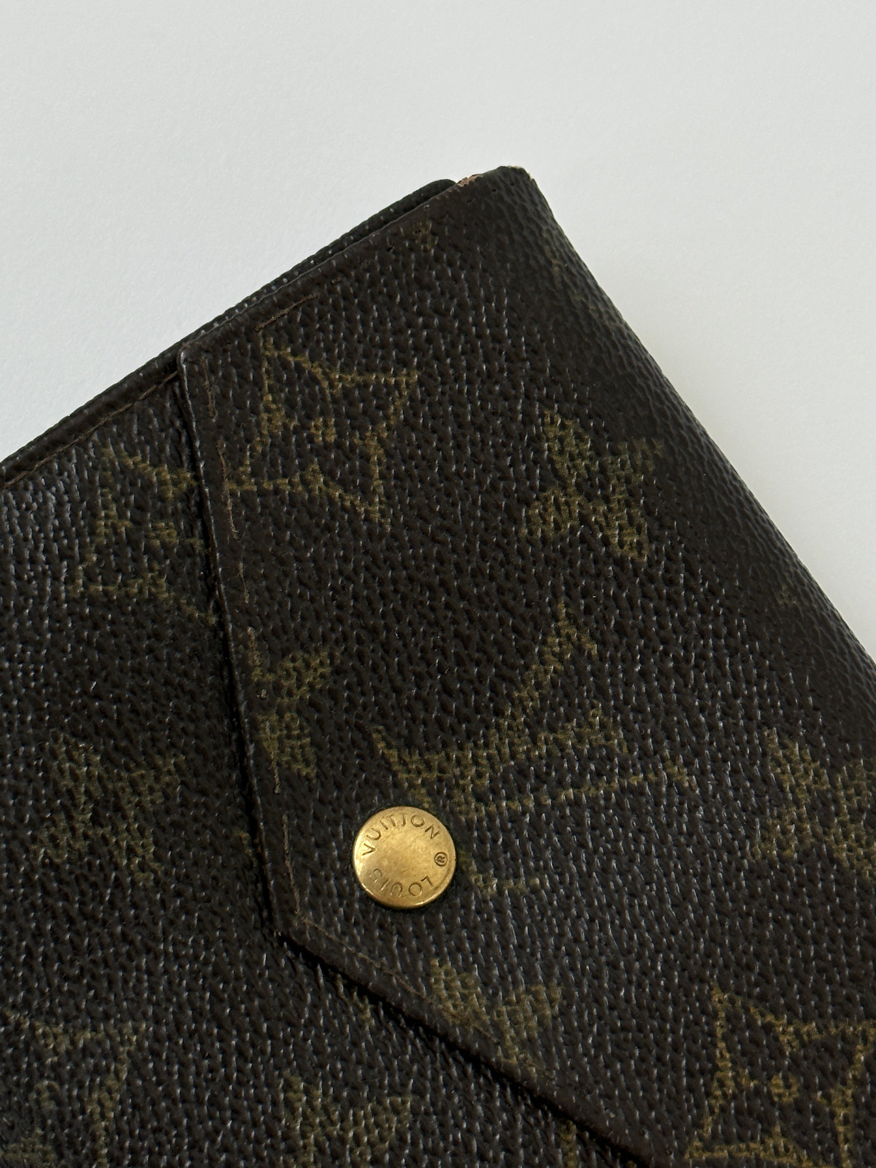 Louis Vuitton 1989 Monogram wallet with signature LV monogram canvas and leather trim, displayed open showing card slots and interior.