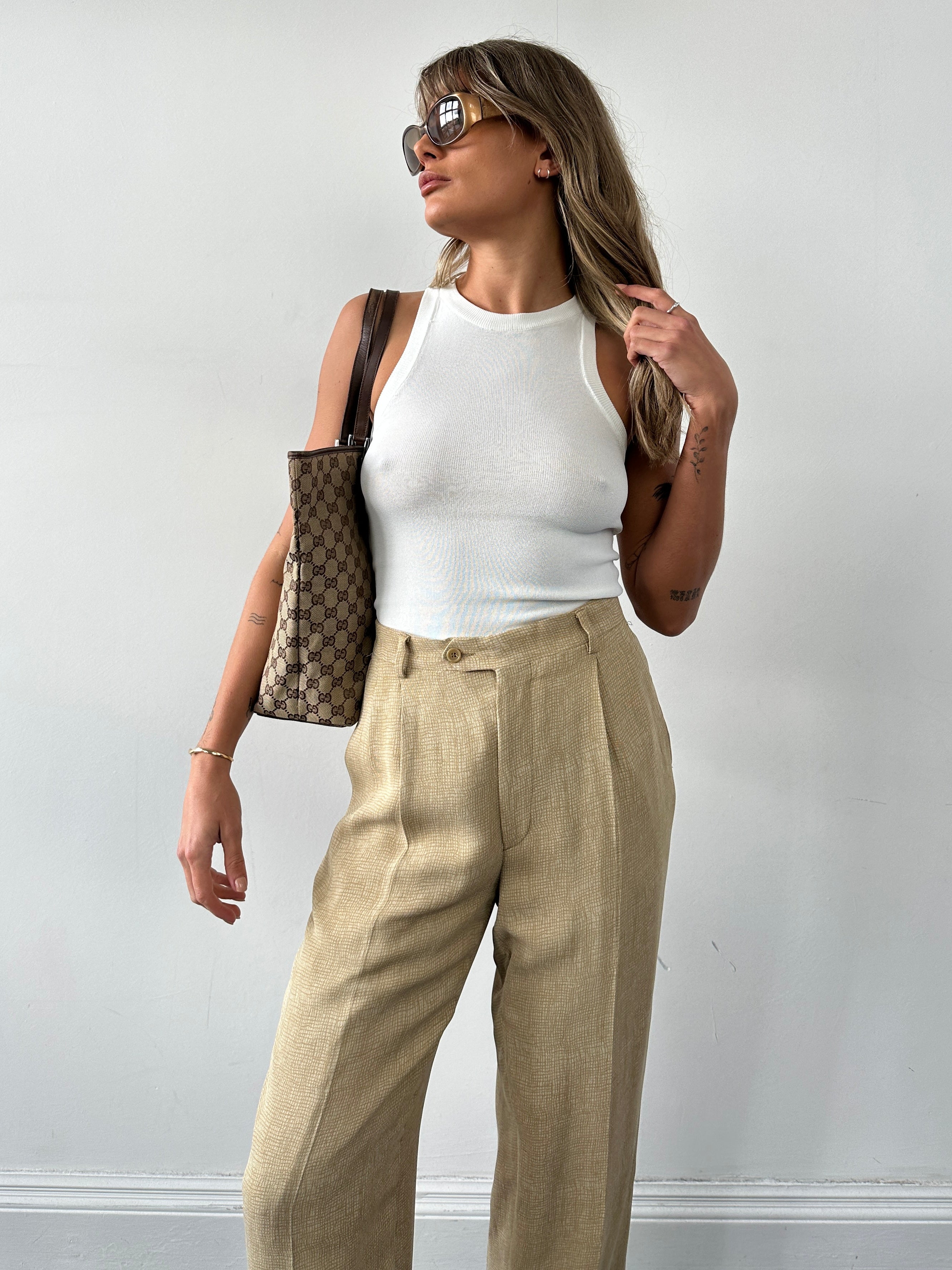 Gucci Monogram GG bucket tote bag with leather straps and logo pattern, shown from front view.