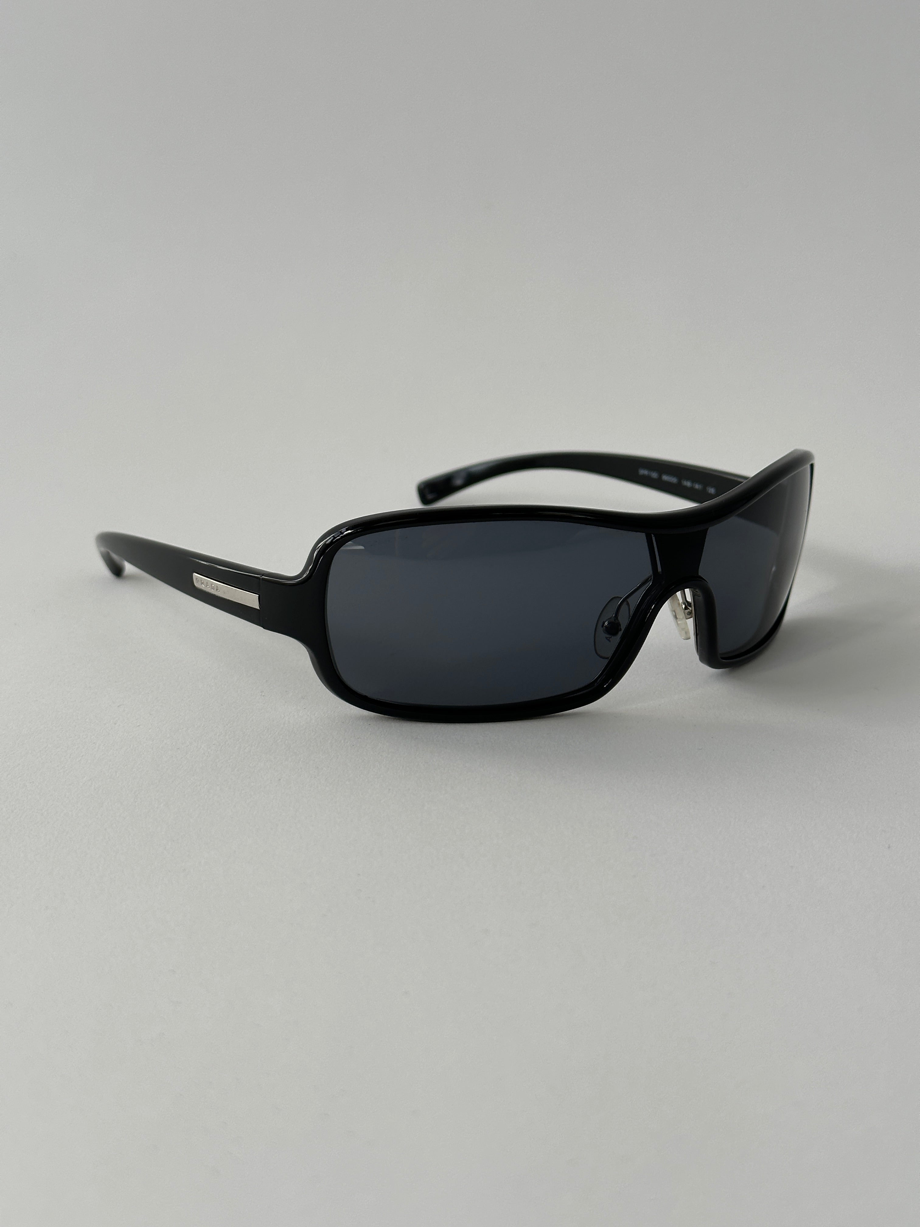 Prada 2000s shield sunglasses with dark tinted lenses and sleek black frame, stylish eyewear for a modern look.