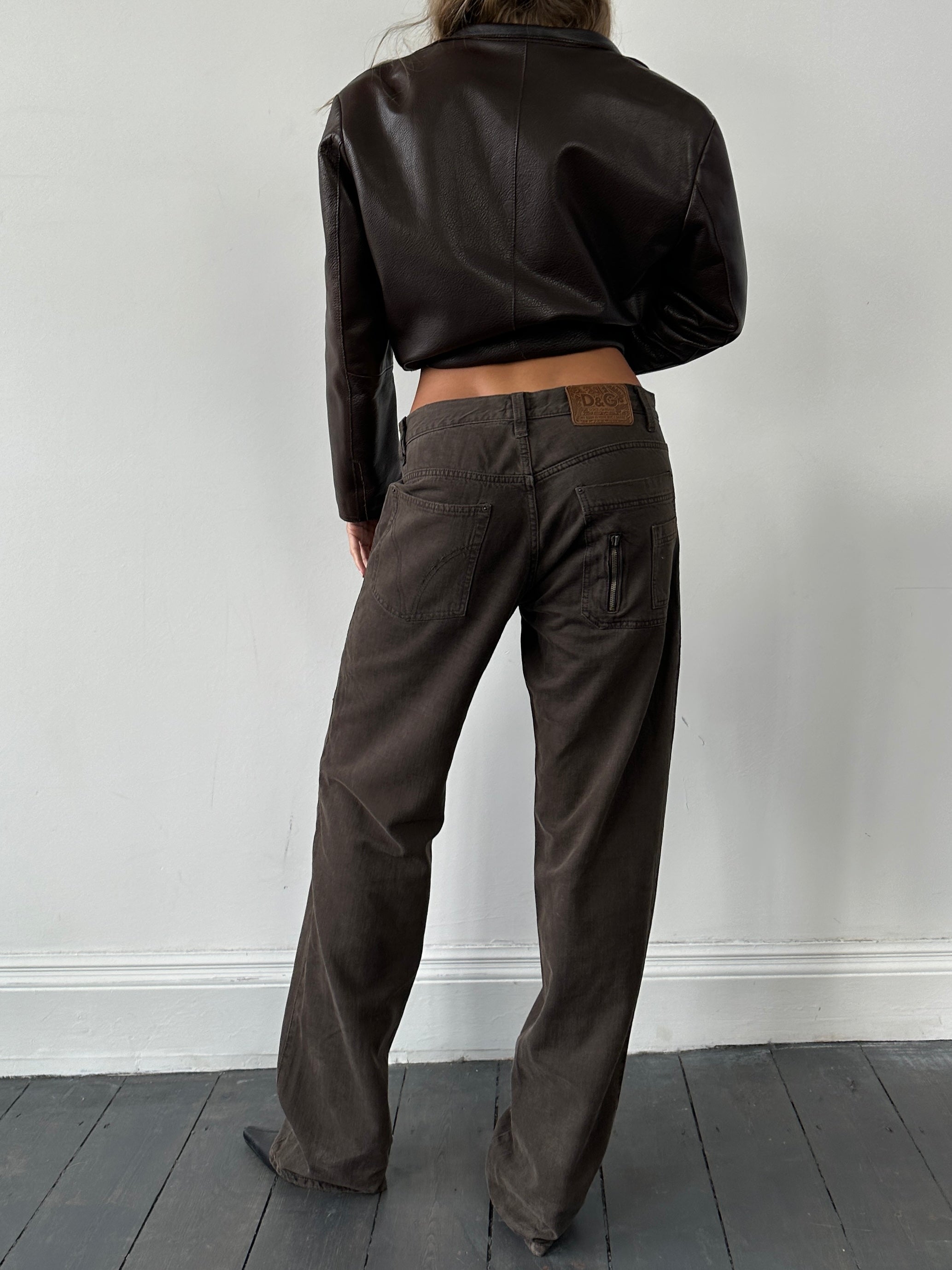Dolce & Gabbana 90s denim straight-leg mid-rise jeans in W34 displayed on a hanger with visible stitching and classic blue wash.