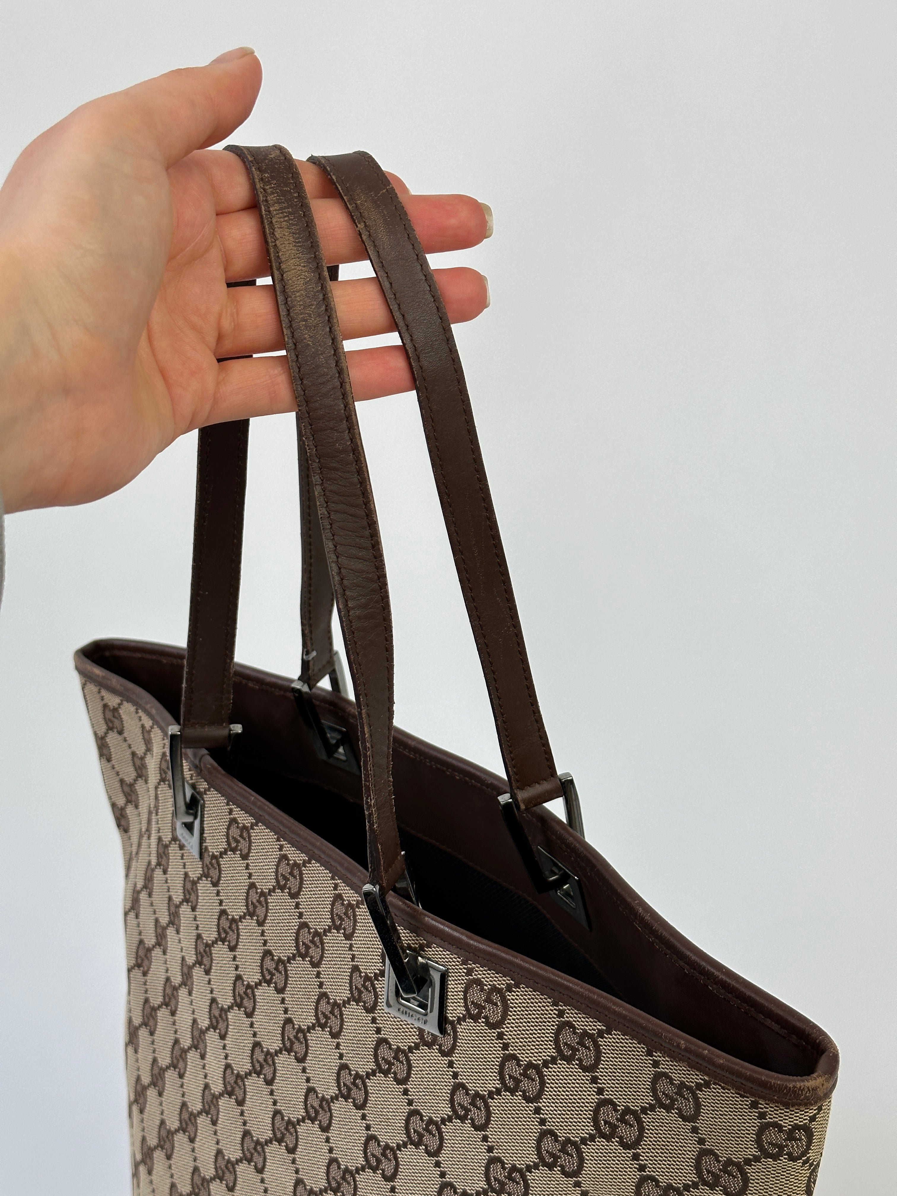 Gucci Monogram GG Bucket Tote Bag featuring the iconic logo pattern and durable leather handles.
