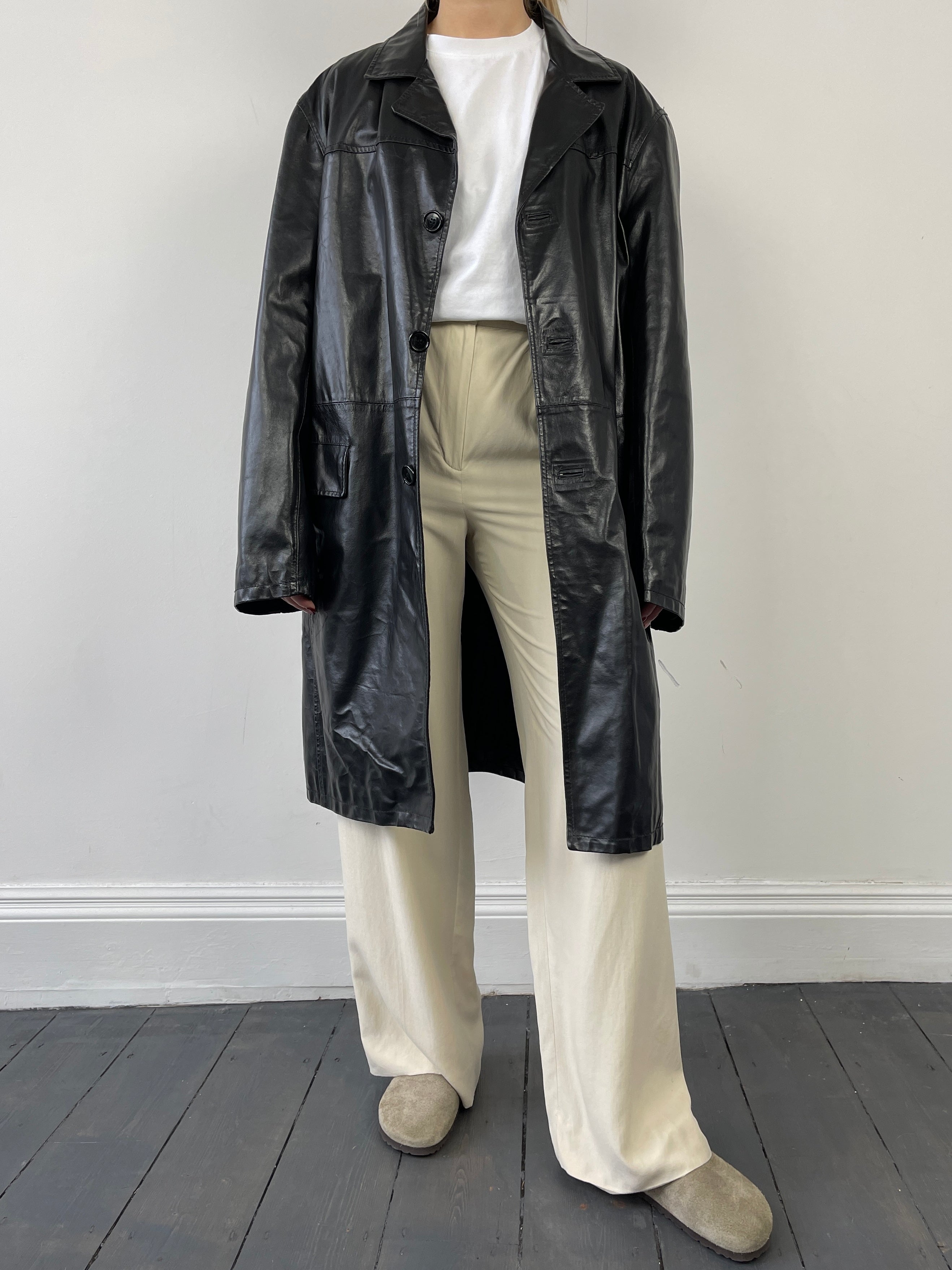 Vintage Italian leather trench coat jacket with classic design, featuring a tailored fit and aged leather finish.