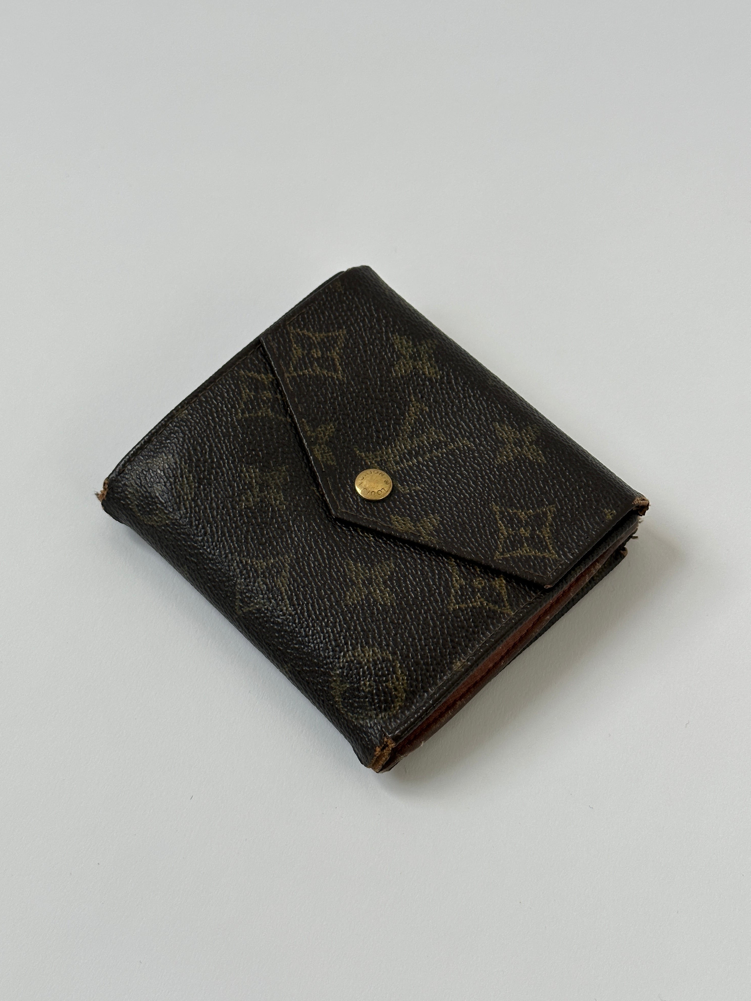 Louis Vuitton 1989 Monogram Wallet with classic monogram pattern, leather trim, and gold-tone hardware.