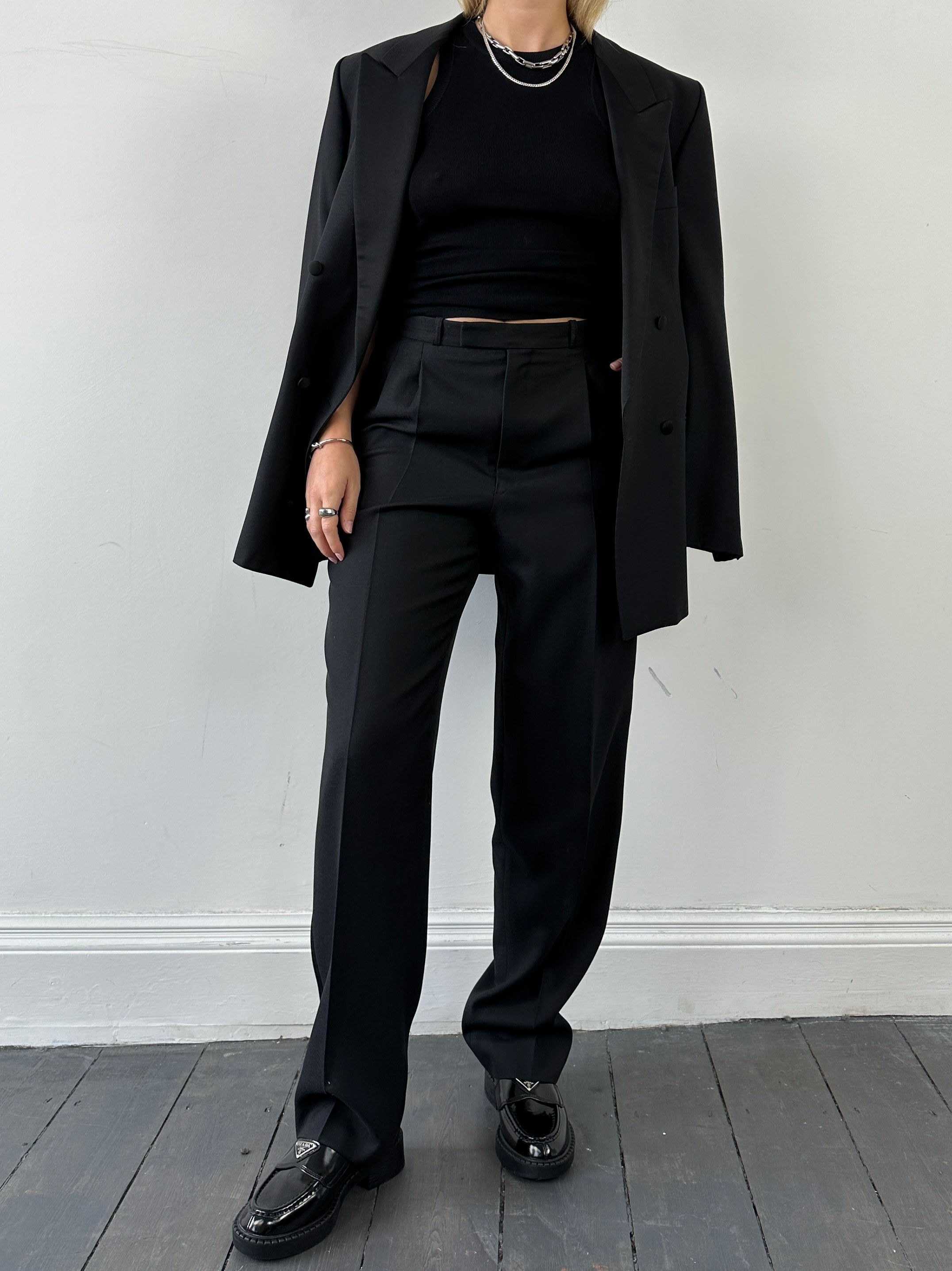 Christian Dior Monsieur tuxedo jumpsuit in double-breasted wool with tailored fit, featuring lapel collar and button details.