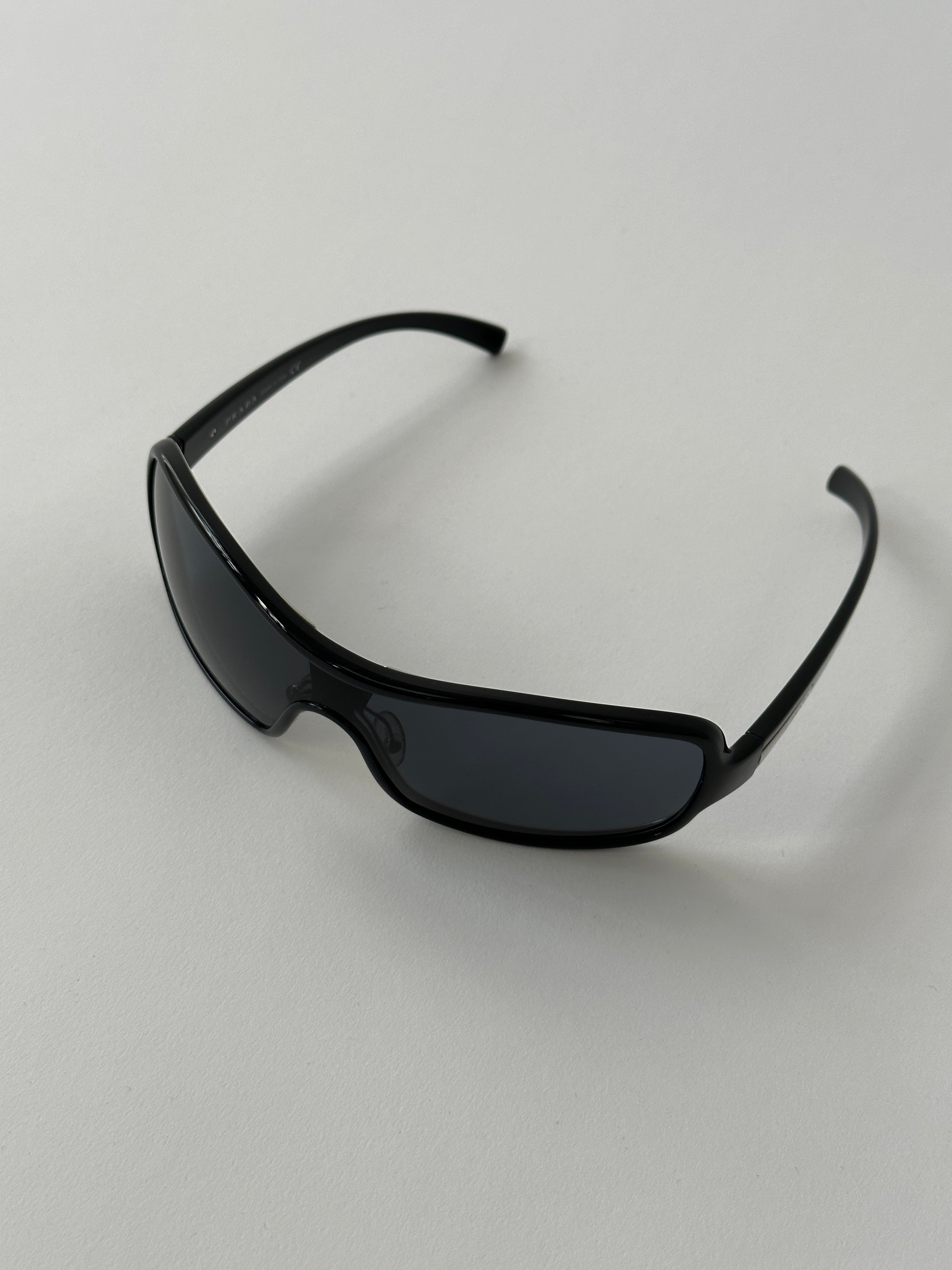Prada 2000s shield sunglasses with dark tinted lenses and black frame, stylish and protective eyewear.