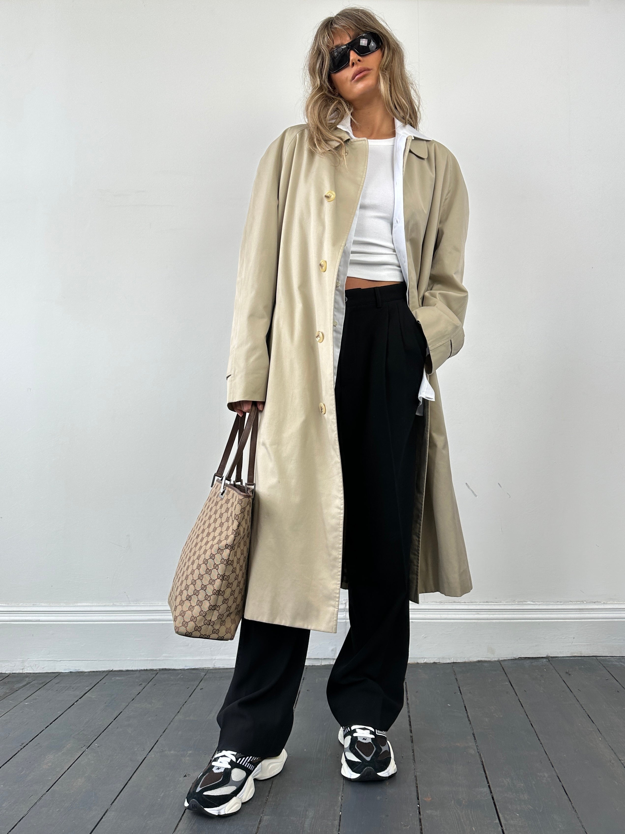 Gucci Monogram GG bucket tote bag showing the signature monogram pattern and sturdy handles on a neutral background.