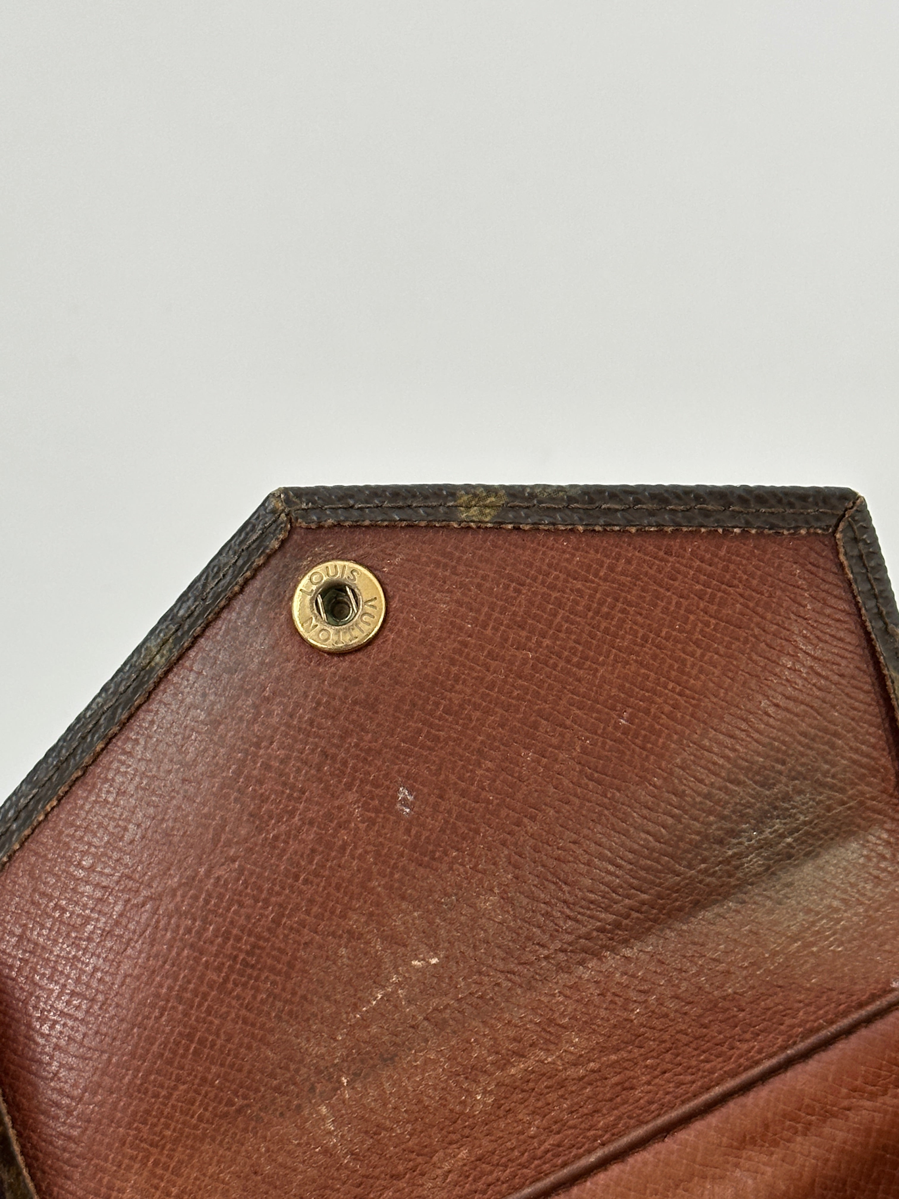 Louis Vuitton 1989 Monogram Wallet with classic LV monogram pattern and leather trim, displayed open showing card slots and interior.