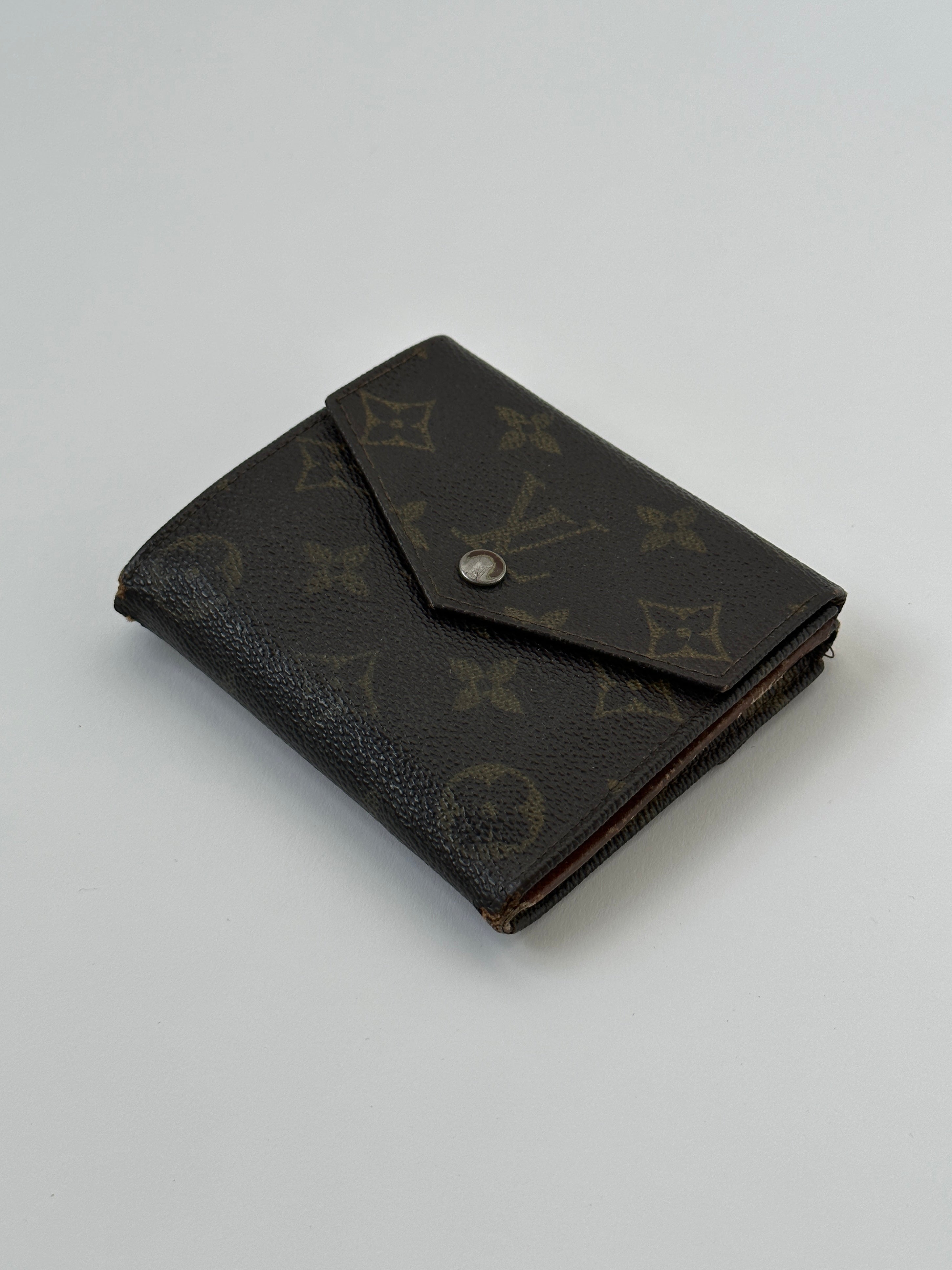 Louis Vuitton 1988 Monogram Wallet with classic monogram canvas and leather trim, featuring multiple card slots and a zip coin pocket.