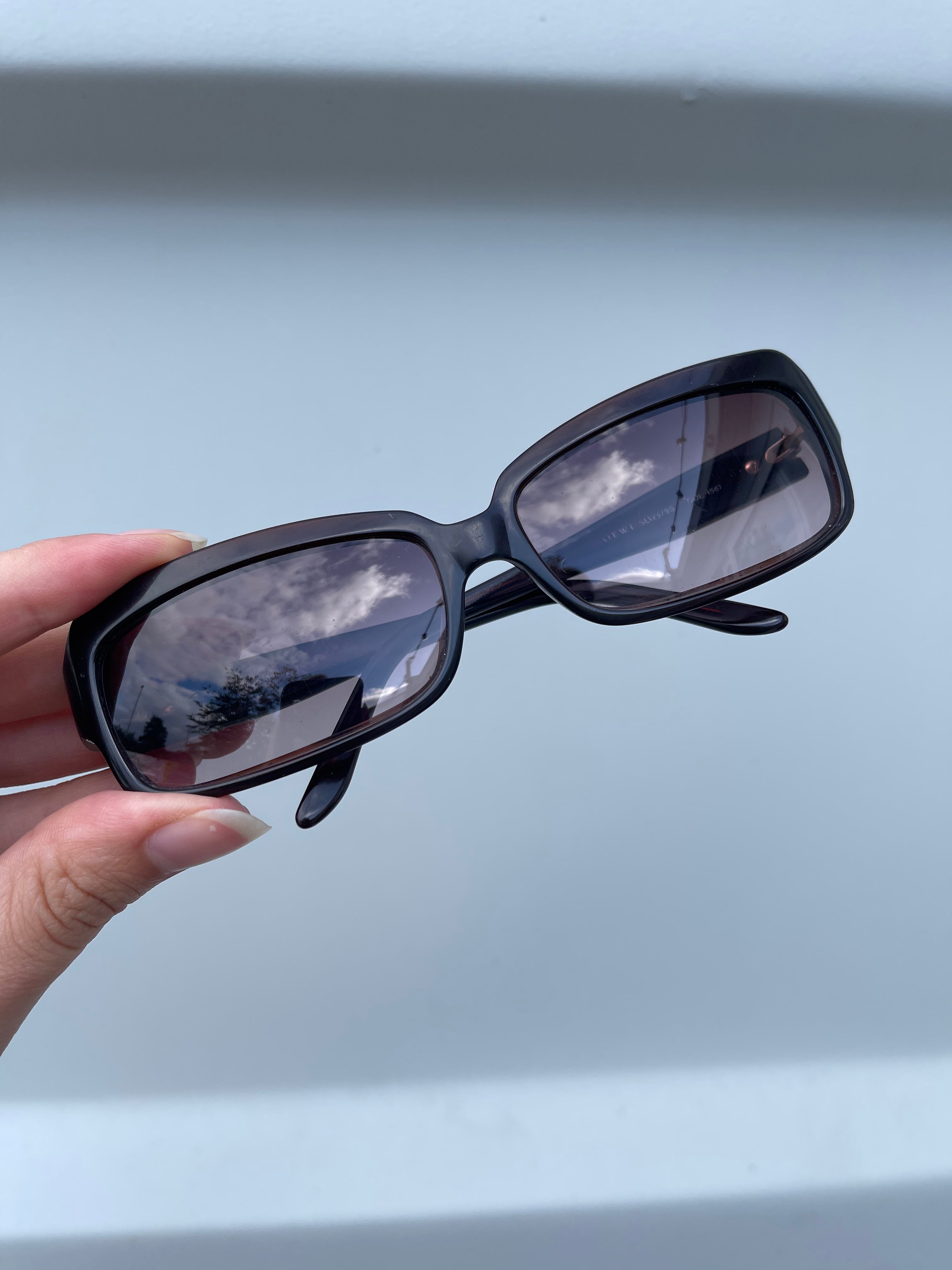 Loewe Rectangle Sunglasses with black frames and dark tinted lenses, stylish eyewear for sun protection.