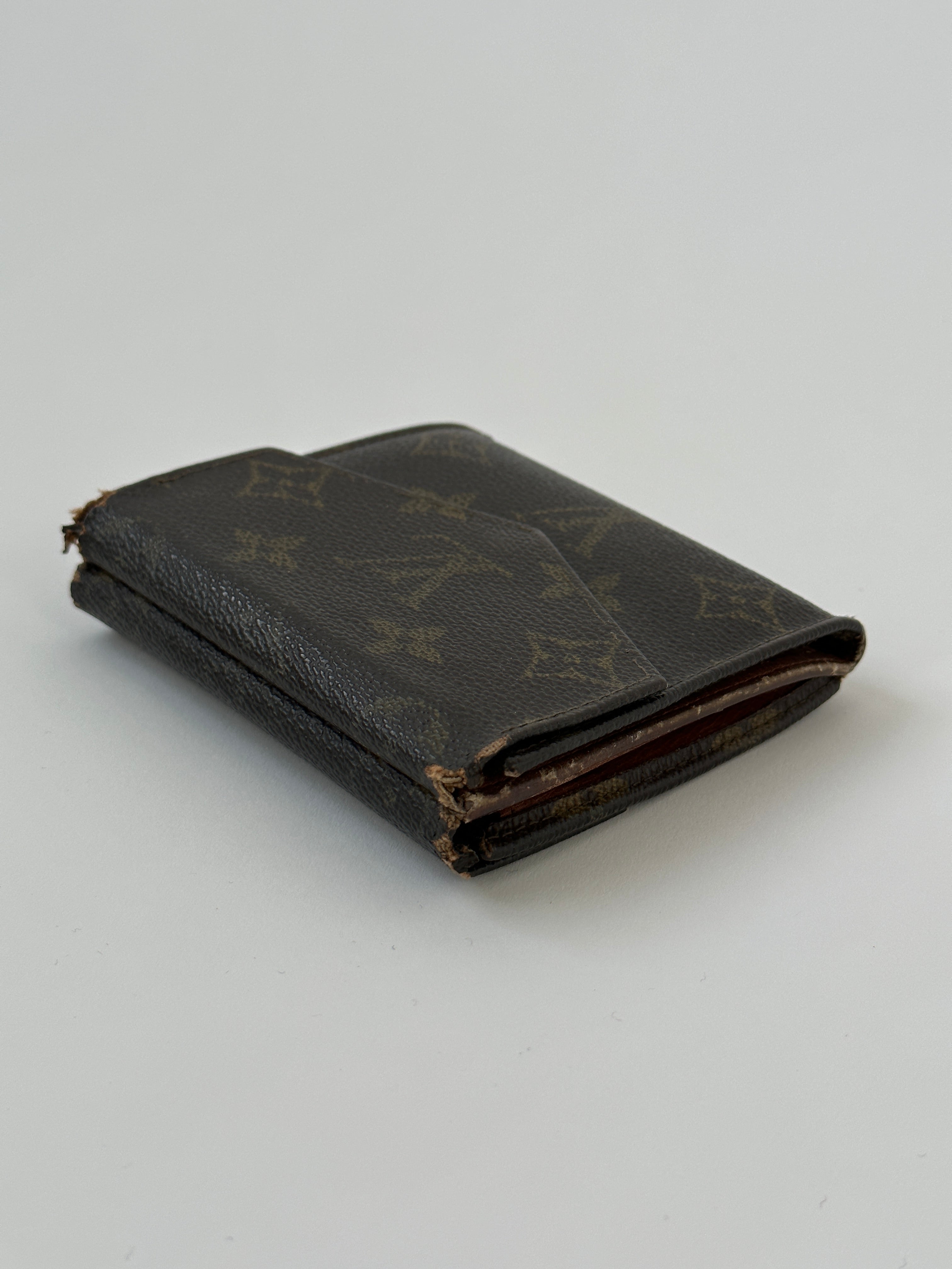 Louis Vuitton 1989 Monogram Wallet showcasing classic monogram canvas and leather trim with multiple card slots and a zip coin compartment.