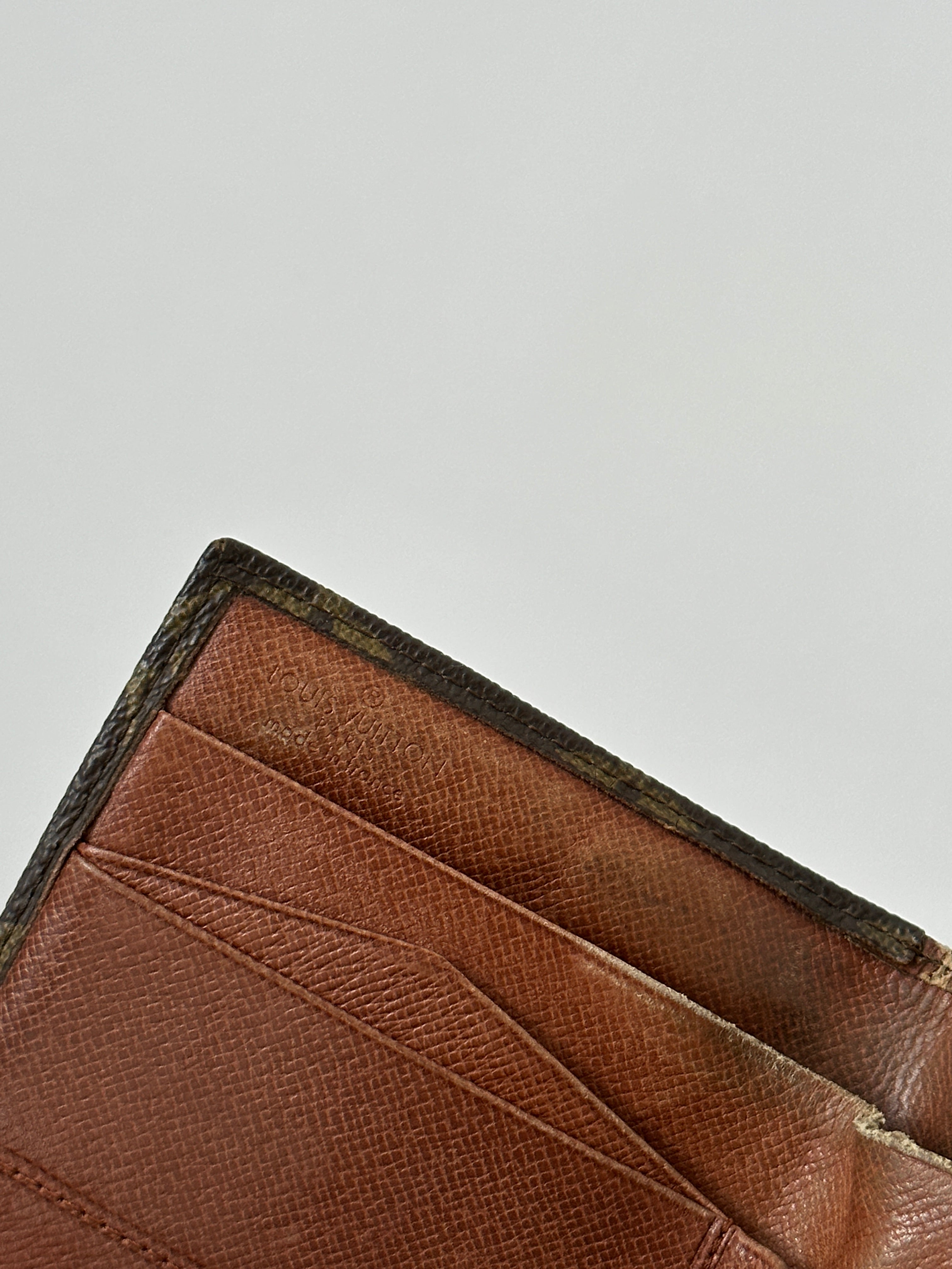 Louis Vuitton 1988 Monogram wallet showing classic monogram canvas and gold-tone zipper with multiple card slots.