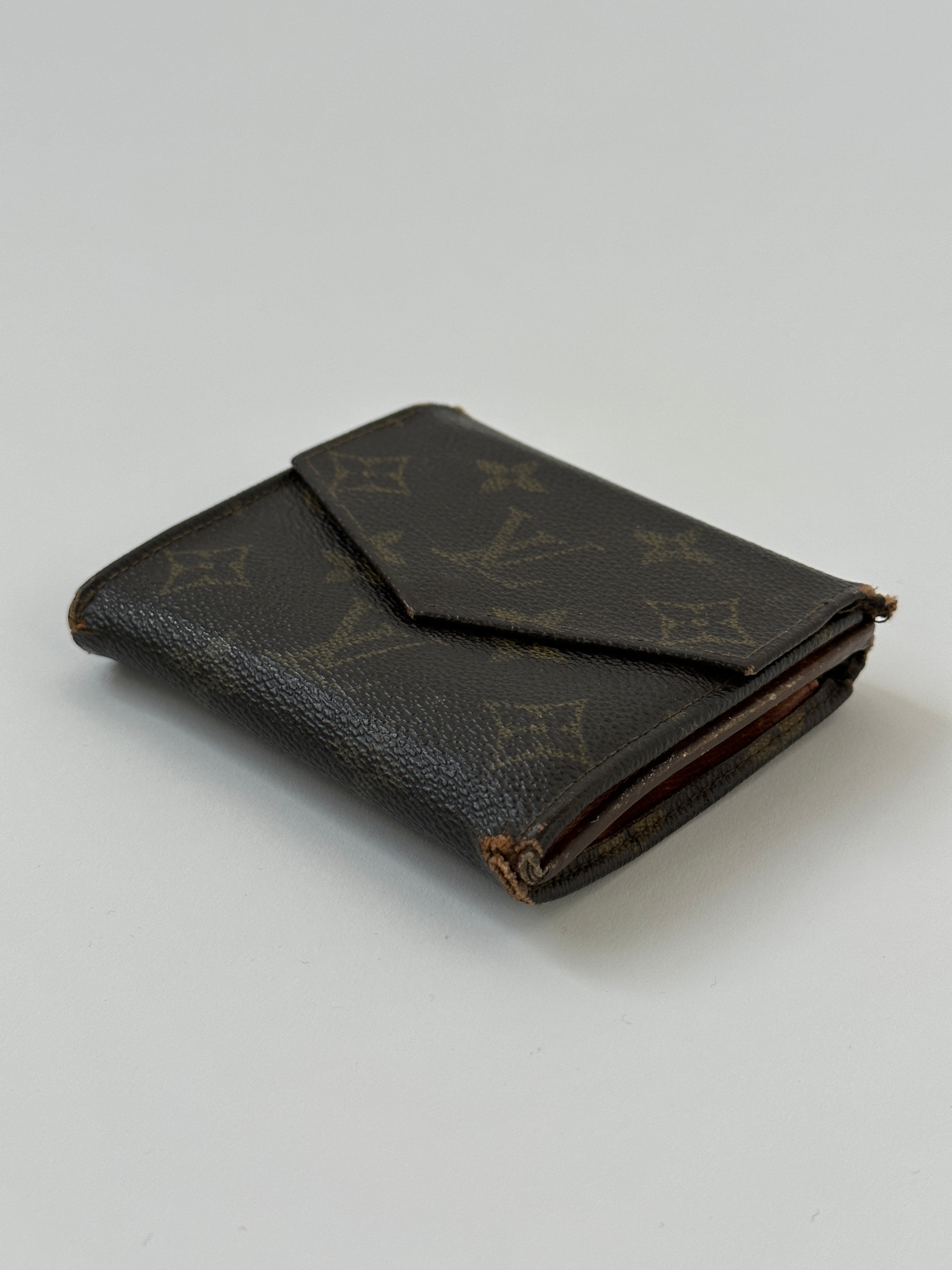 Louis Vuitton 1989 Monogram wallet with classic monogram canvas and leather accents, front view showing zipper closure.