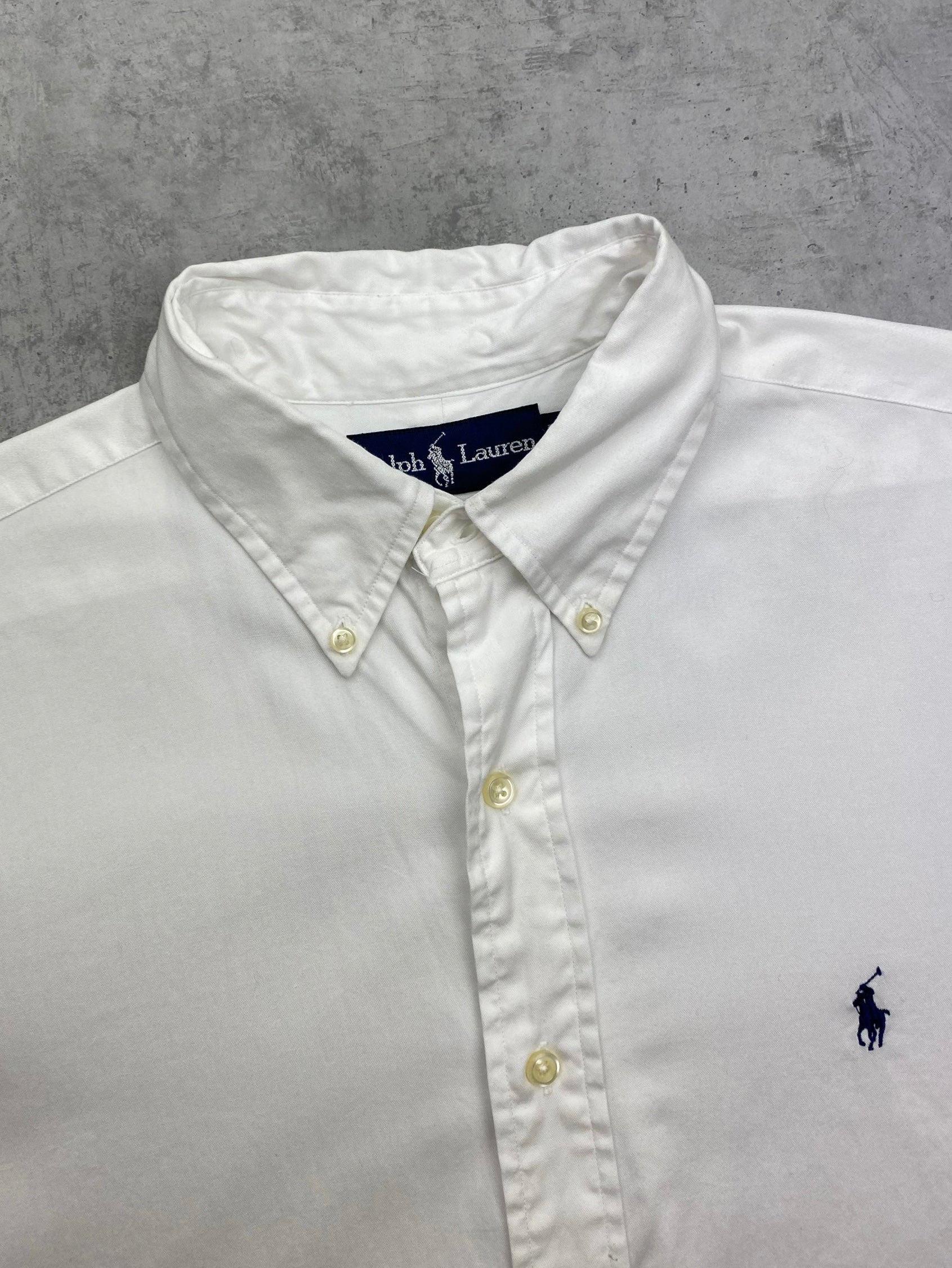 Ralph Lauren cotton shirt displayed flat, featuring classic collar, button front, and long sleeves in a light blue color.