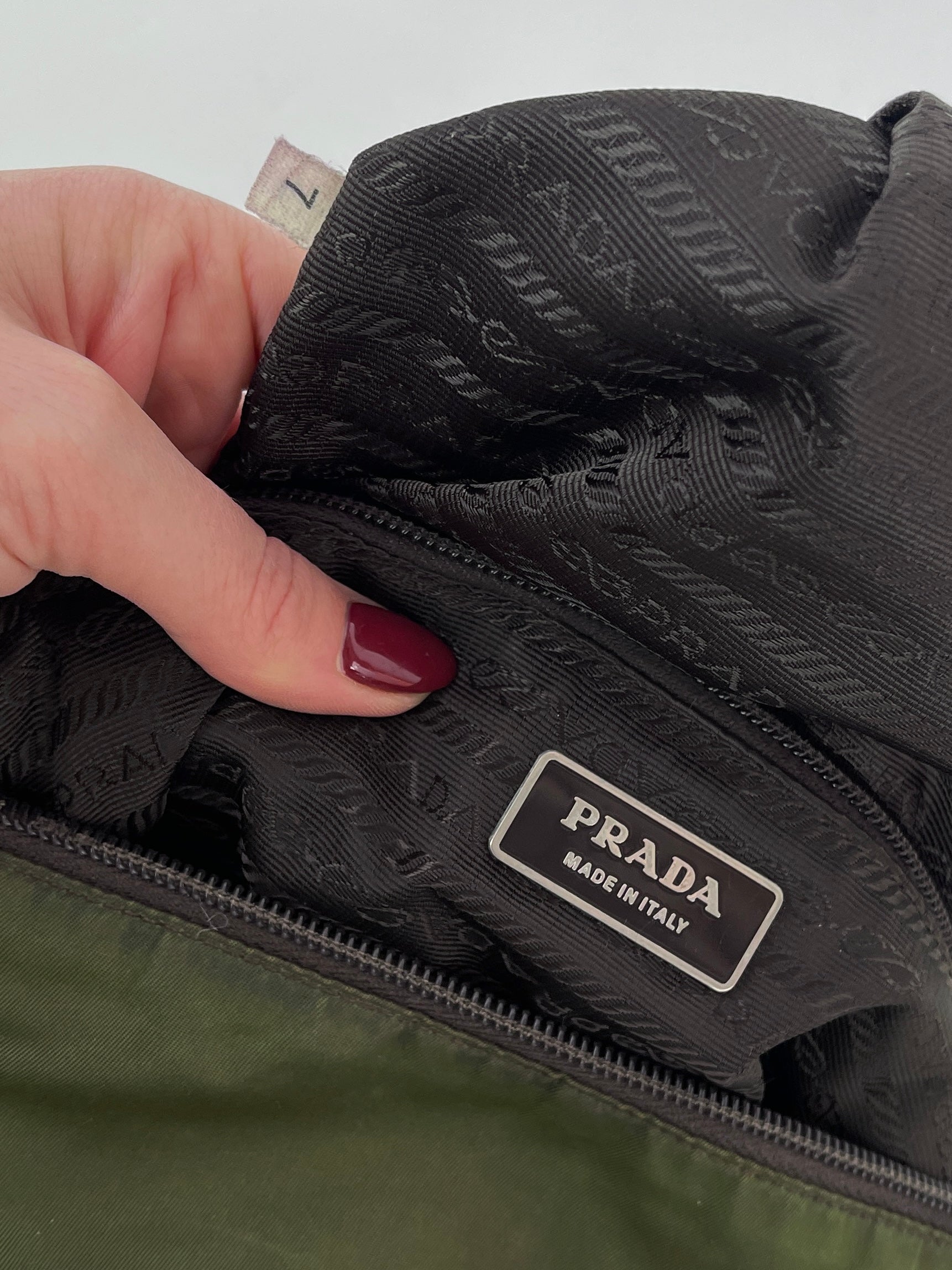 Prada nylon crossbody bag with adjustable strap and sleek design, featuring the Prada logo on the front.