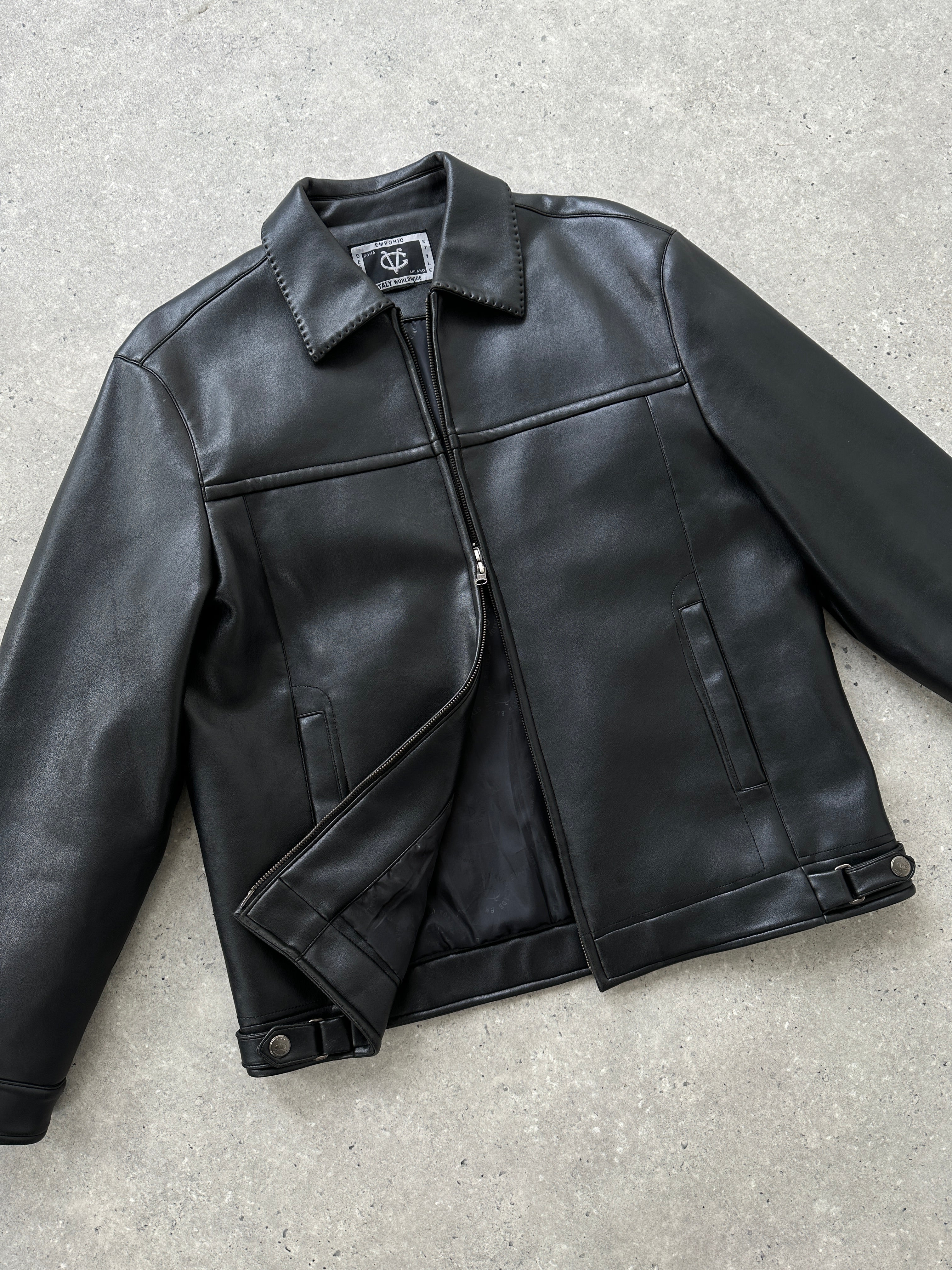 Vintage double zip faux leather jacket in size M/L with classic design and silver hardware, styled for a retro look.