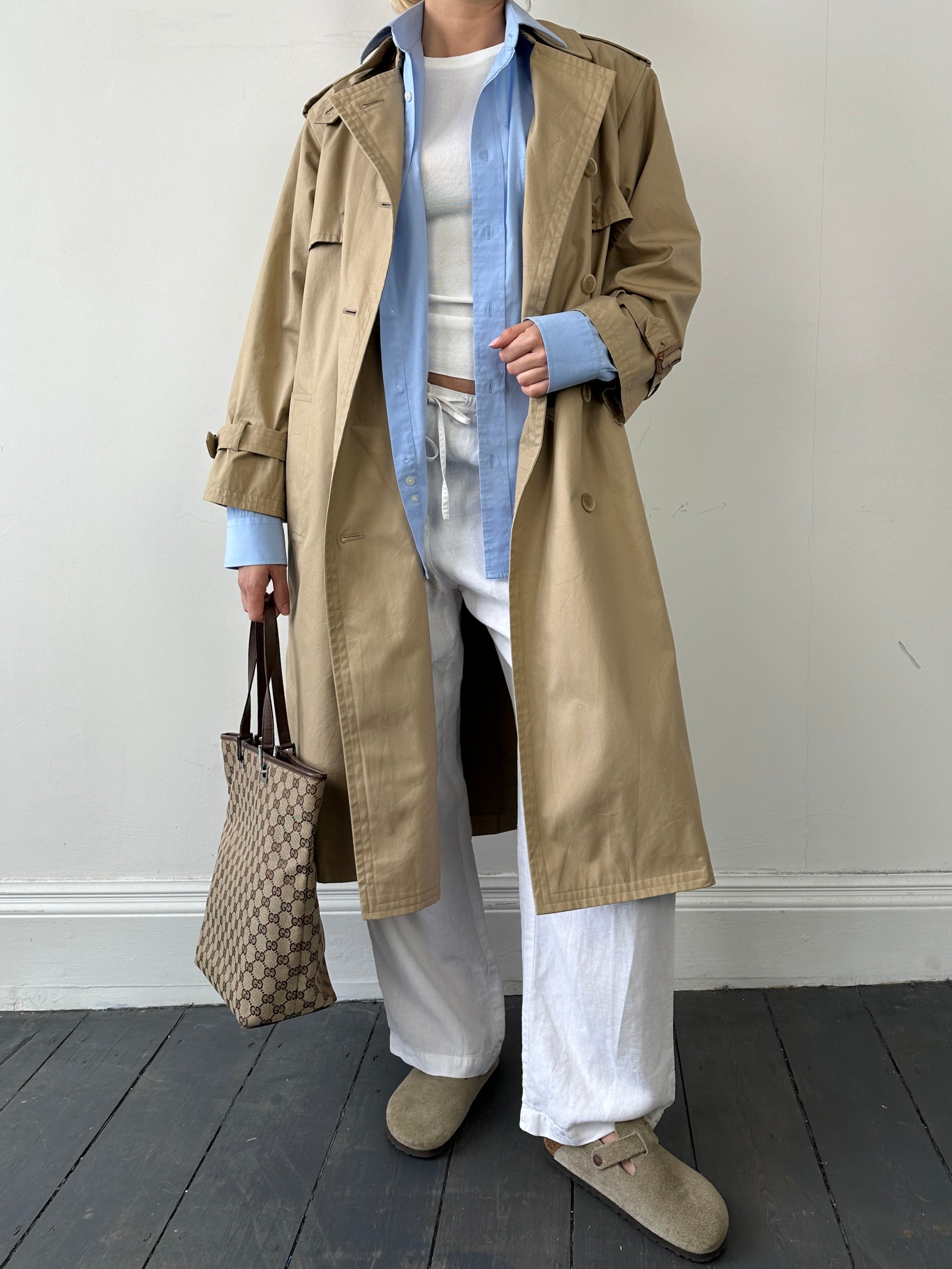 Yves Saint Laurent Paris double-breasted trench coat in size M, featuring classic design with belt and tailored fit.