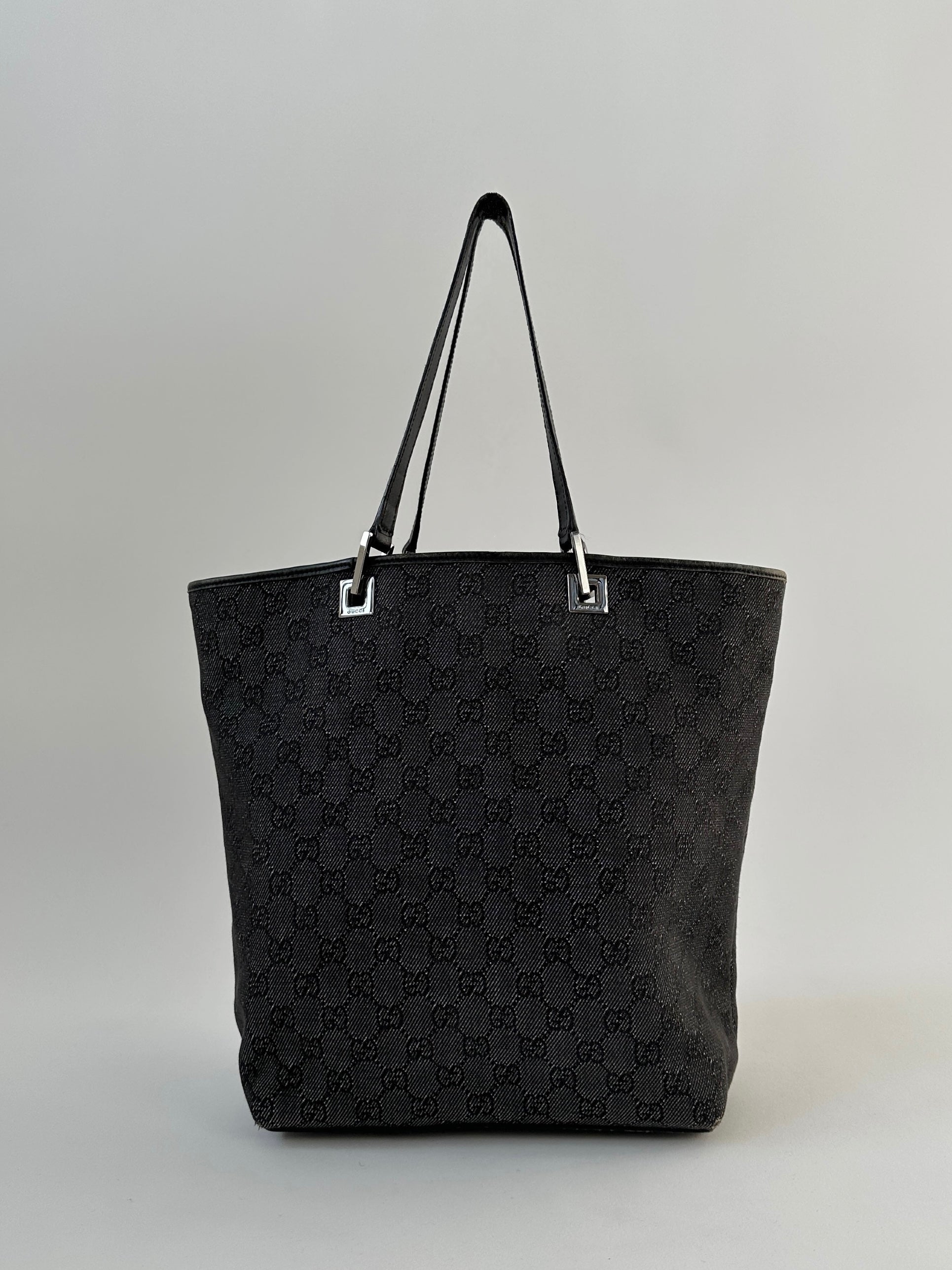 Gucci Monogram GG bucket tote bag with fabric handle and signature pattern, showcasing the luxury designer's classic style.