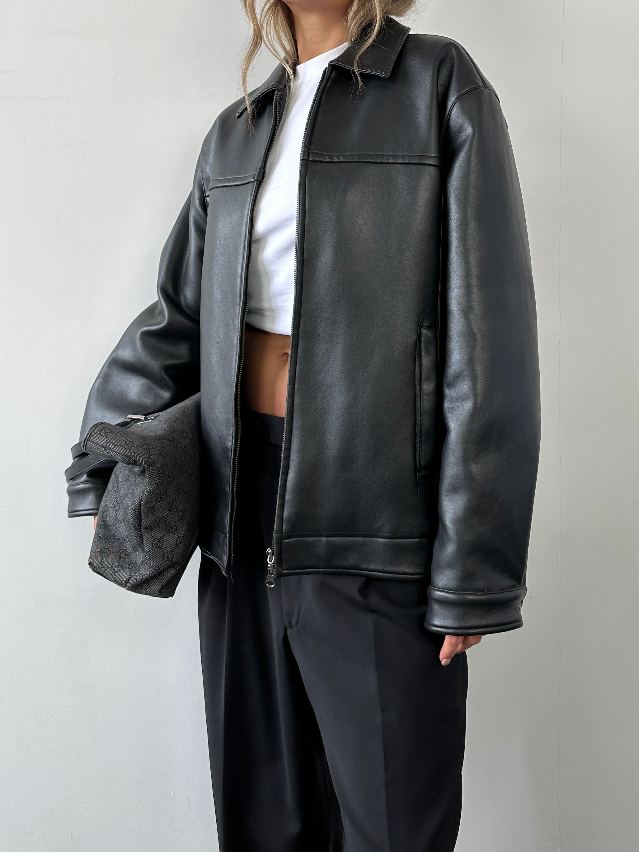 Vintage double zip faux leather jacket in black, front view showing metal zippers and classic collar detail.