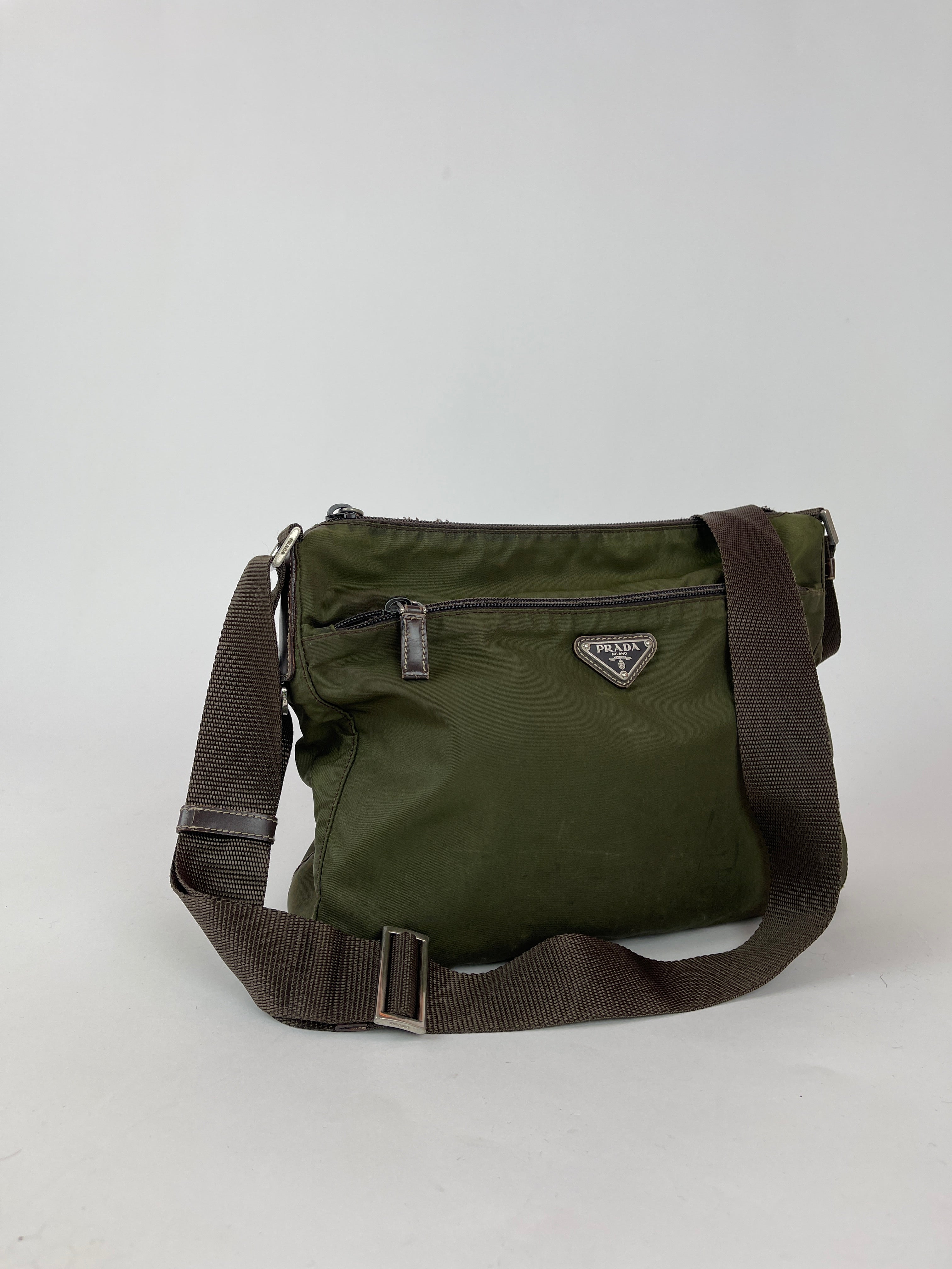 Prada nylon crossbody bag featuring sleek design, adjustable strap, and signature Prada logo on the front.