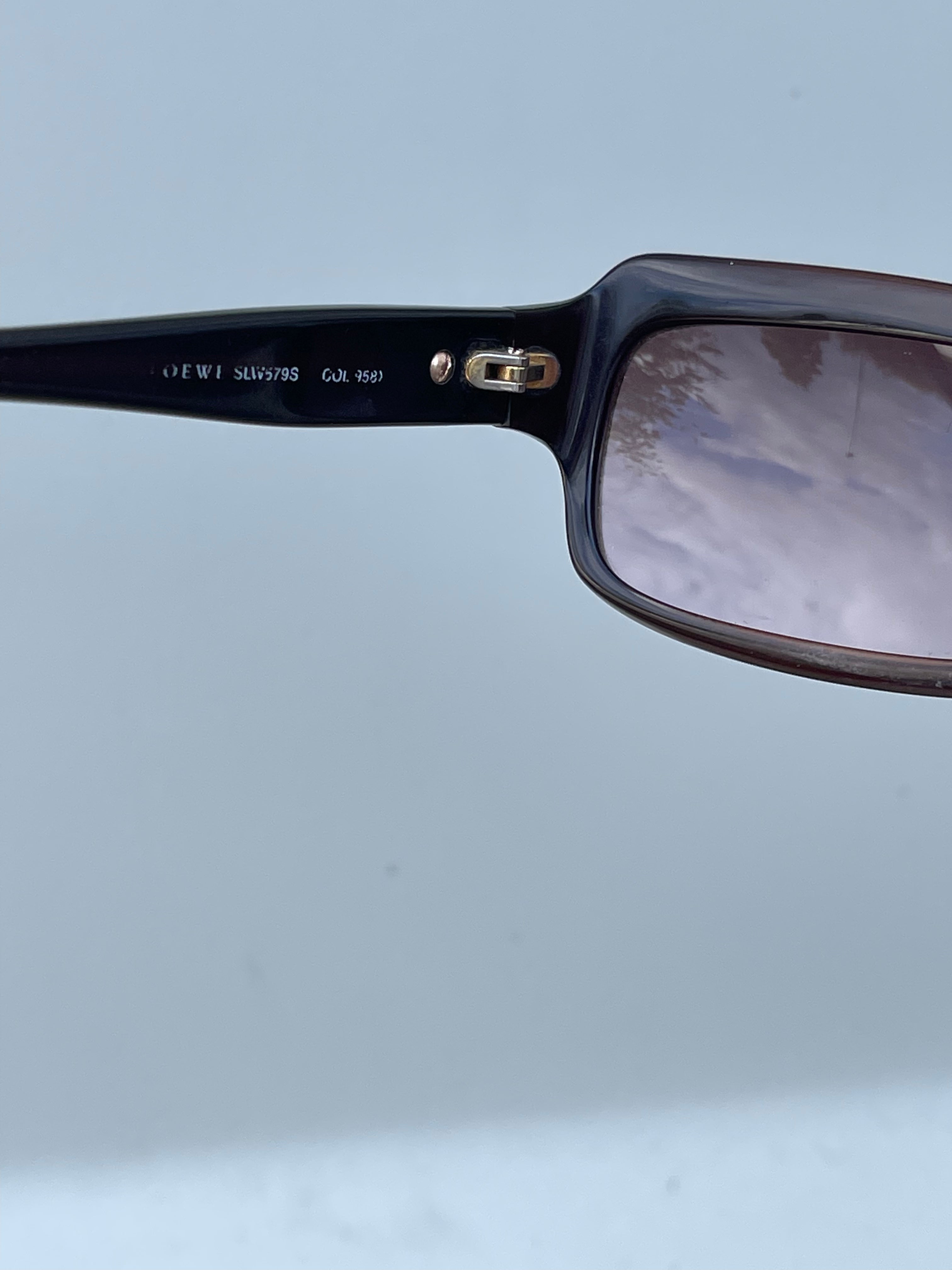 Loewe rectangle sunglasses with thick black frames and dark lenses, stylish and modern eye protection accessory.