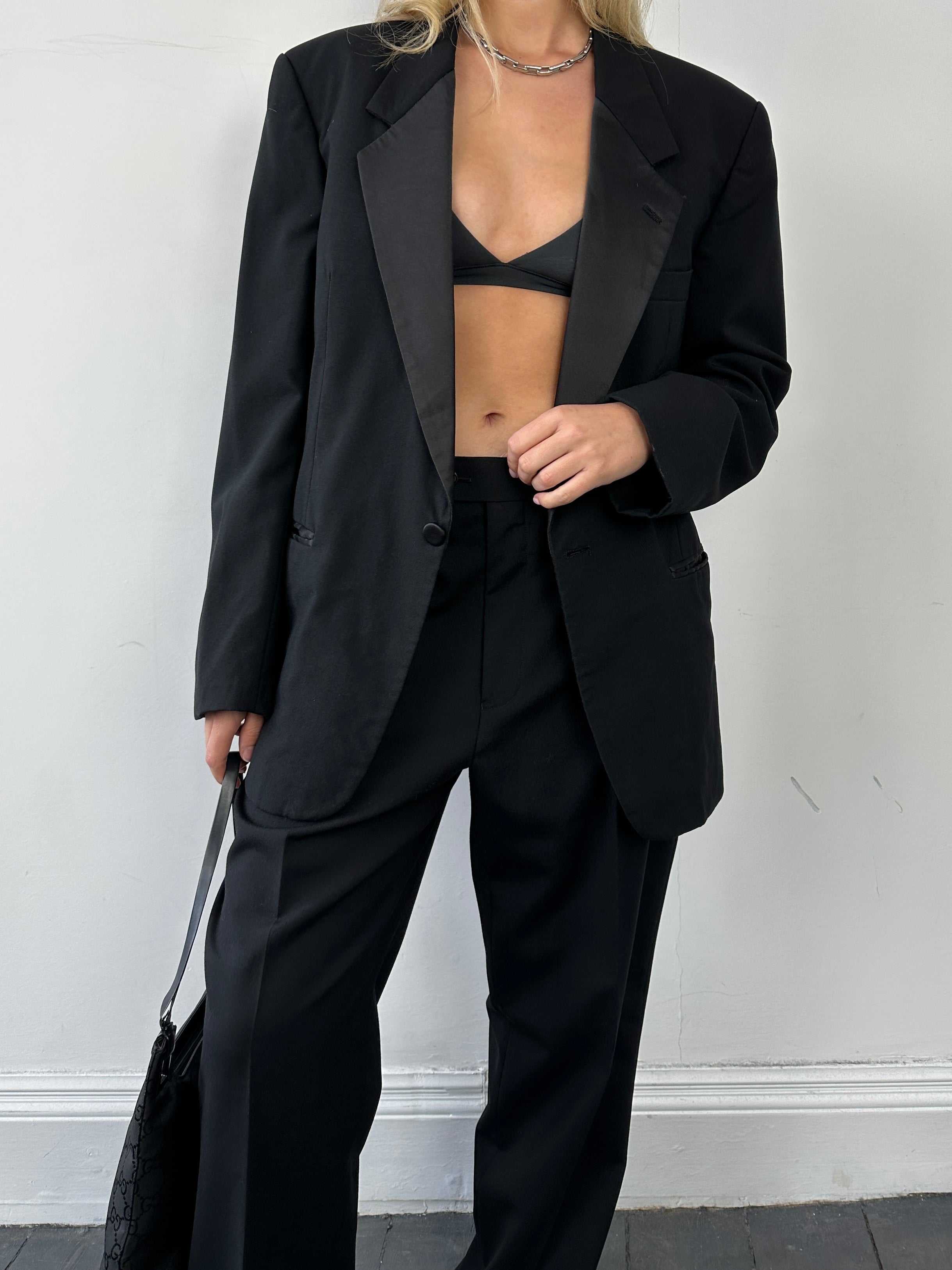 Christian Dior single-breasted wool tuxedo blazer, tailored fit, with notch lapel and button closure, shown on a mannequin.